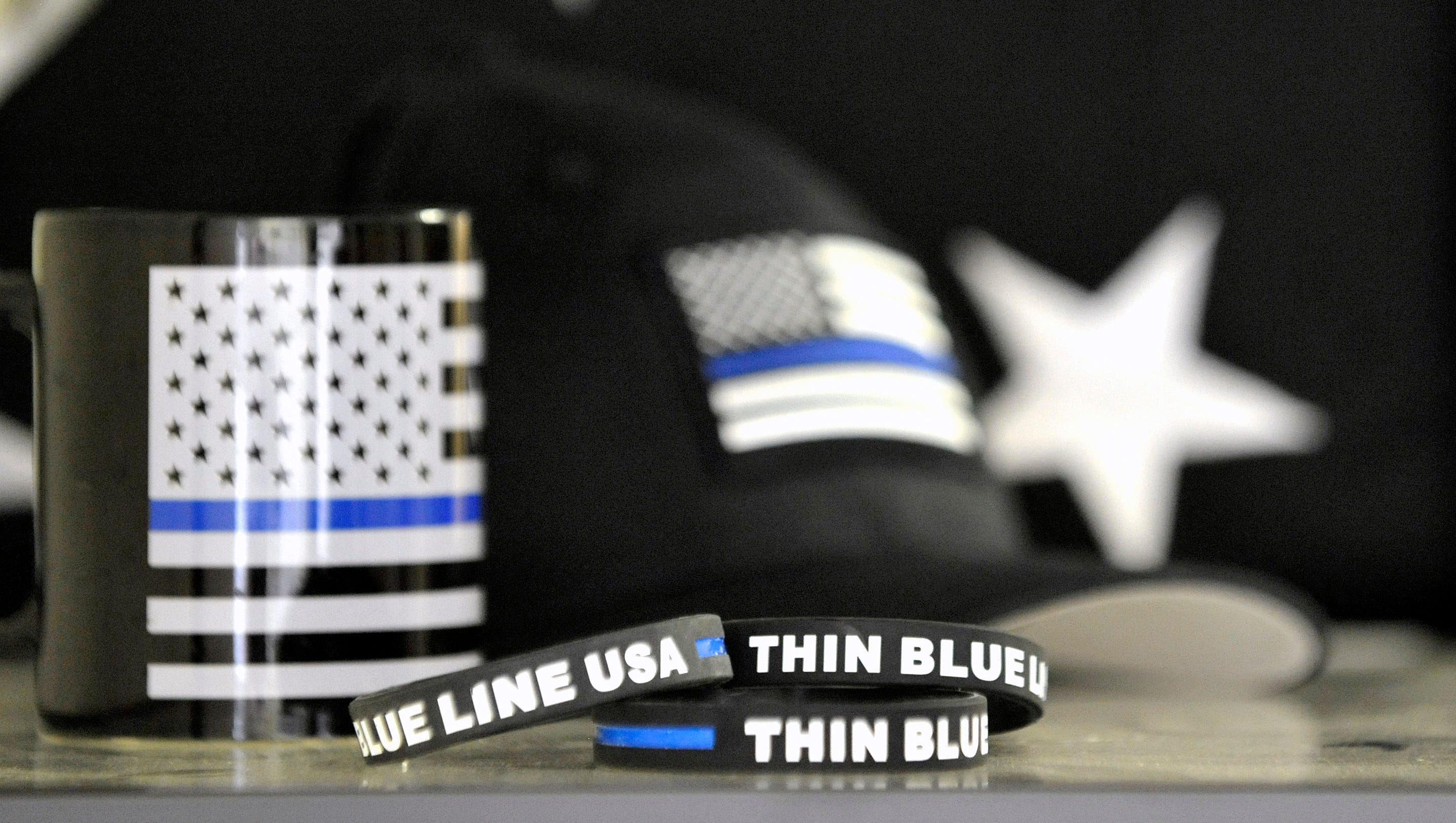 TBL USA products include coffee mugs, hats, flags and wrist bands.