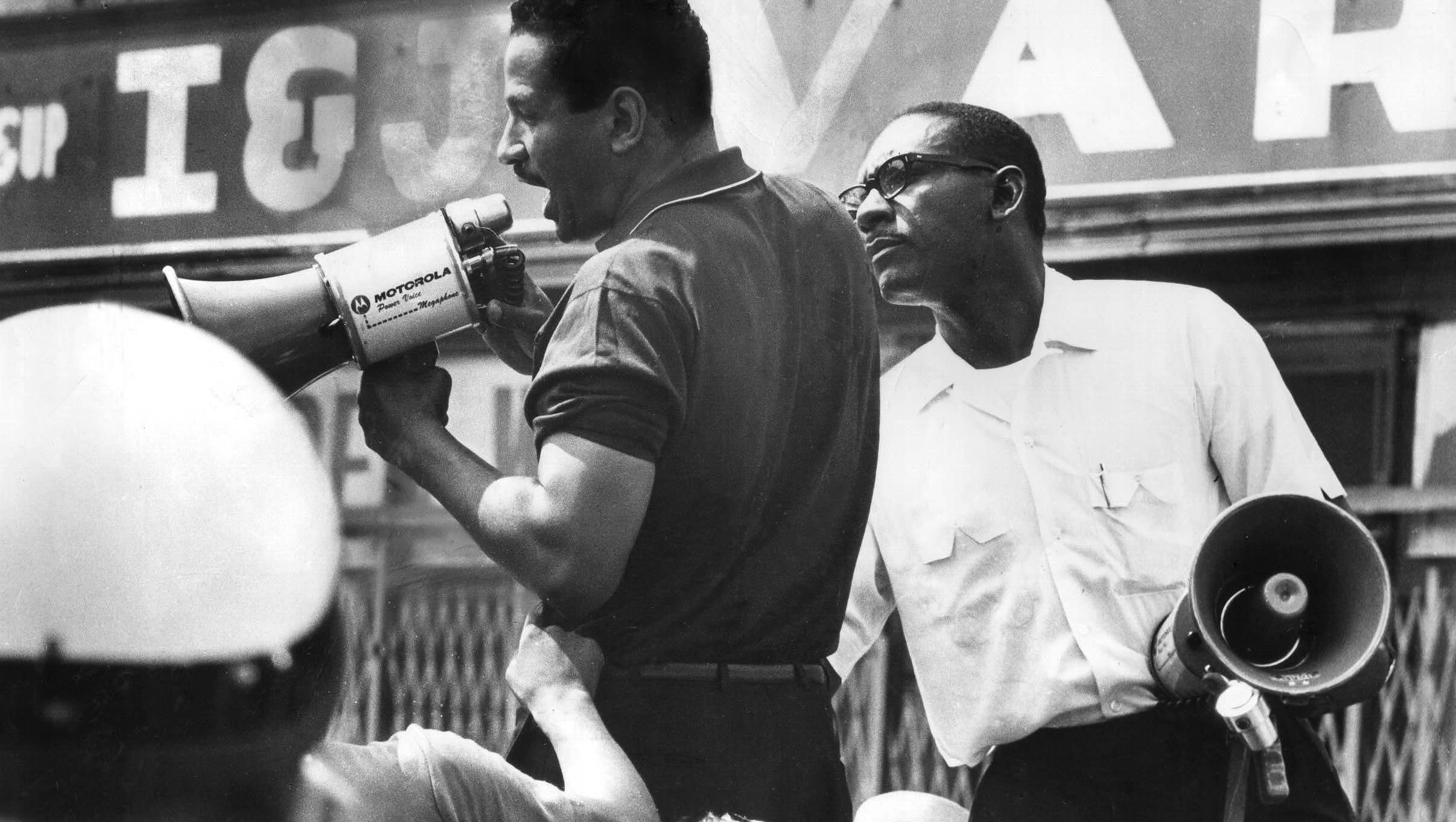 Rep. John Conyers addresses a crowd with a megaphone at 12th and Clairmount  during the 1967 Detroit riots. His pleas for peaceful protests went largely unheeded, but it cemented his reputation as a leader in the civil rights movement.
