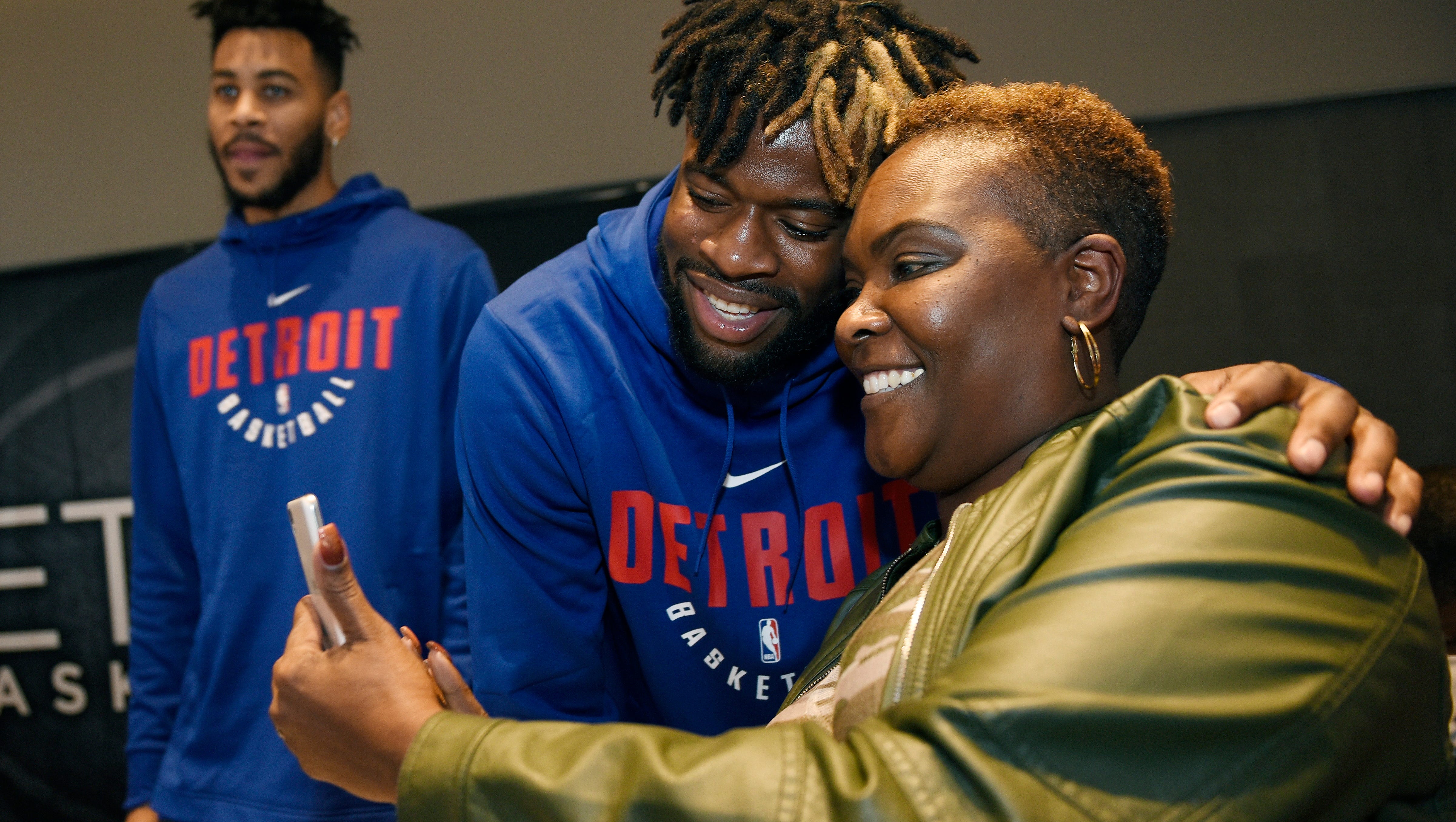 Linda Chupp, 52, of Woodhaven, takes a selfie with Piston Reggie Bullock during the Meet the Team event.
