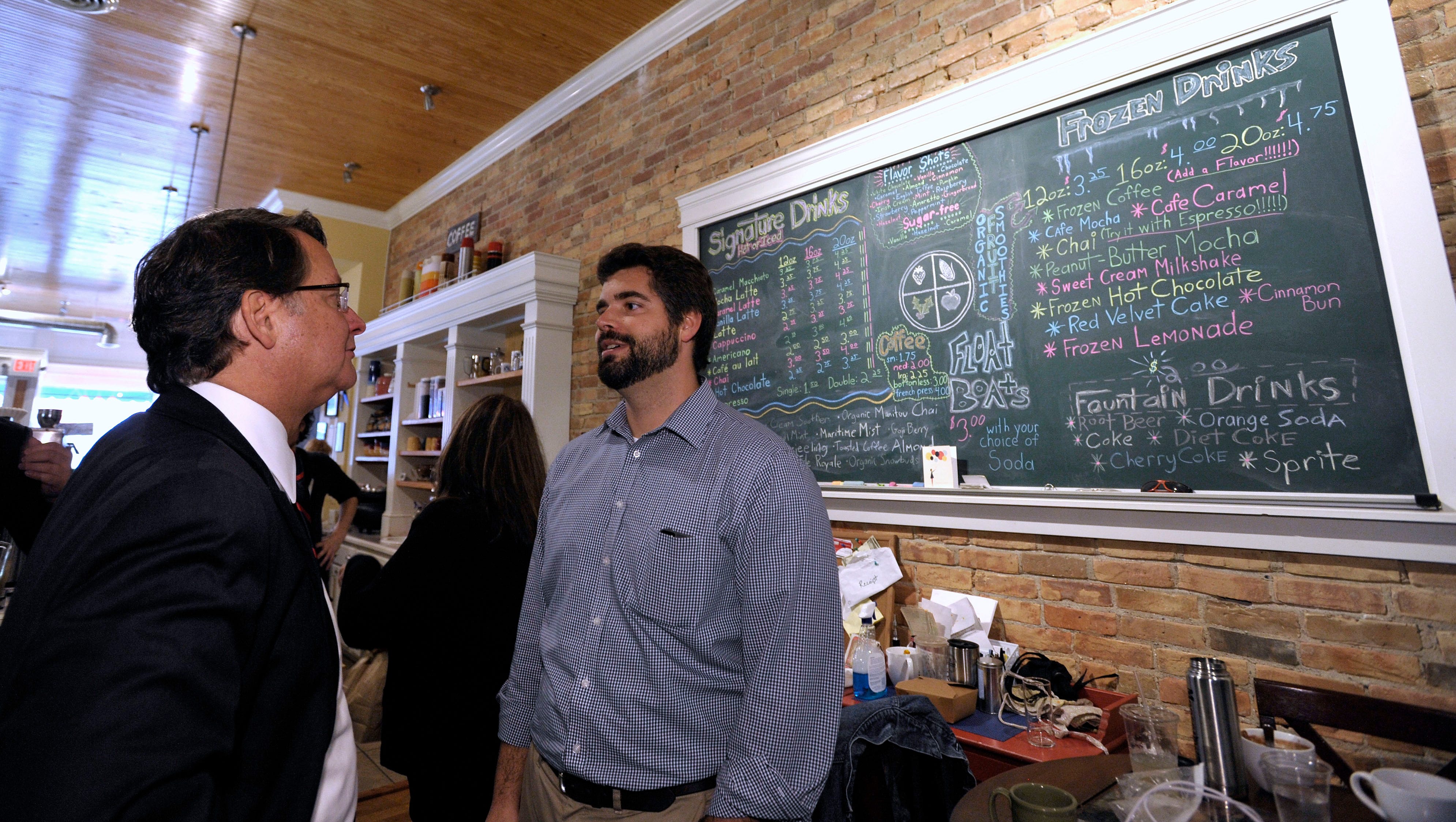 U.S. Congressman Gary Peters, left, talks with Port Huron Family Chiropractic owner Joshua Varty, 28, of Emmett, before lunch at Kate's Downtown.
