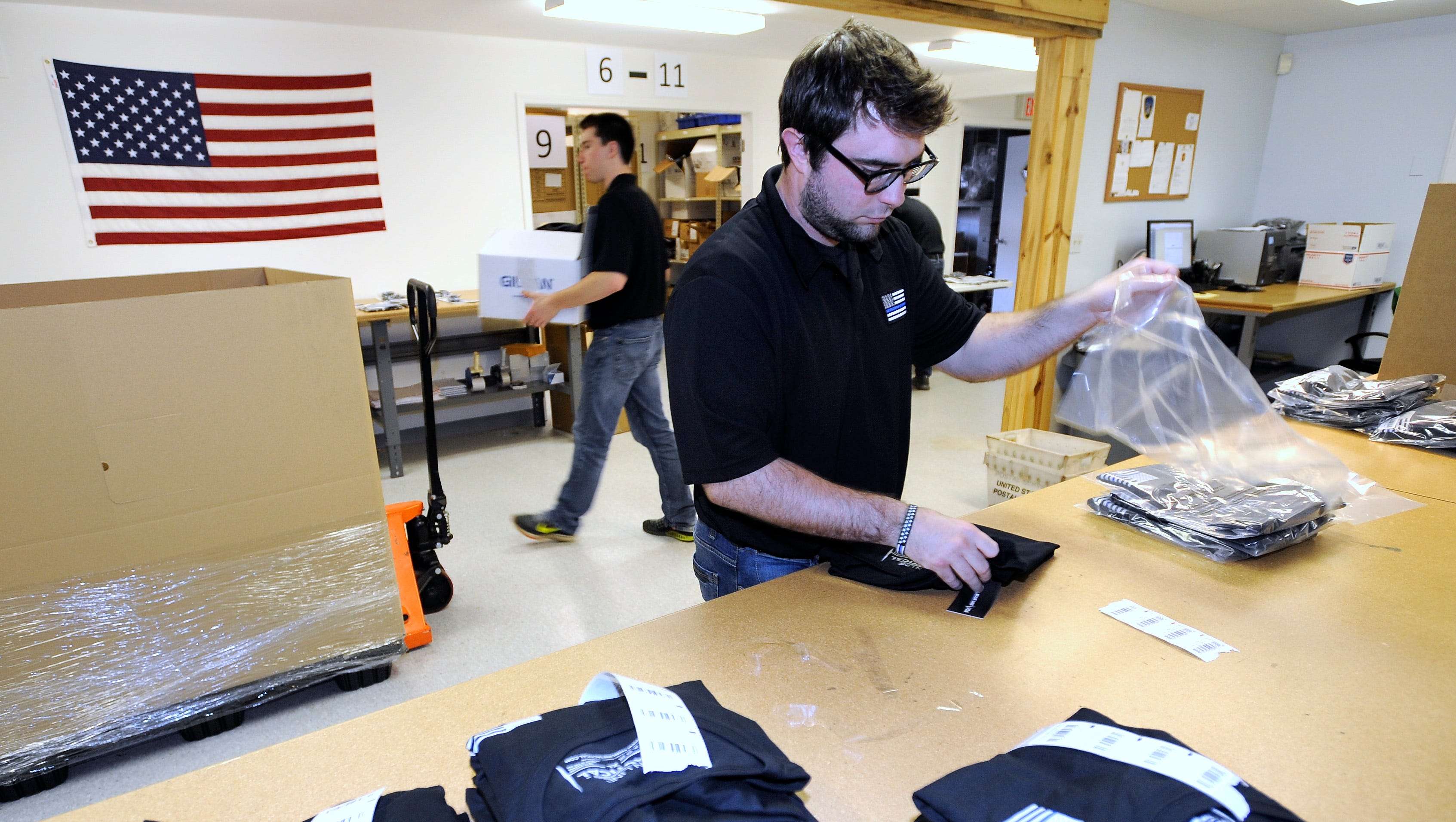 Jon Gaffke, 27, of Plymouth, packages Thin Blue Line USA T-shirts to ship to the Portland, Oregon Police Museum.