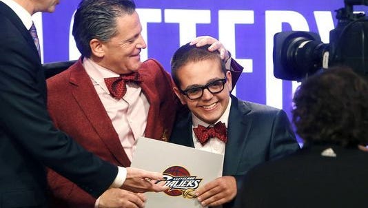 In this May 21, 2013, file photo, Cleveland Cavaliers owner Dan Gilbert congratulates his son, Nick Gilbert, after the team won the NBA basketball draft lottery in New York. Nick Gilbert will undergo major brain surgery this week. A team spokesman said the 21-year-old Michigan State student will have the operation in Detroit.