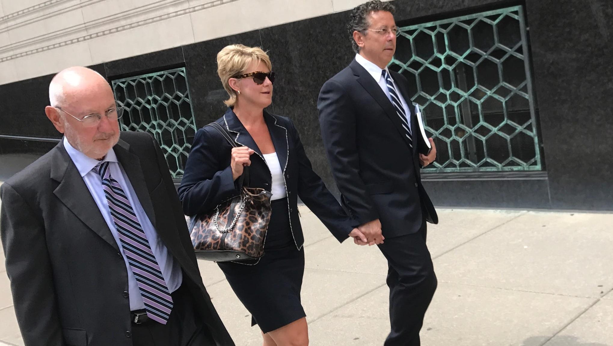 Alphons Iacobelli, far right, leaves the U.S. District Court in Detroit on August 1, alongside Susanne Piwinski-Iacobelli and his lawyer David DuMouchel, left.
