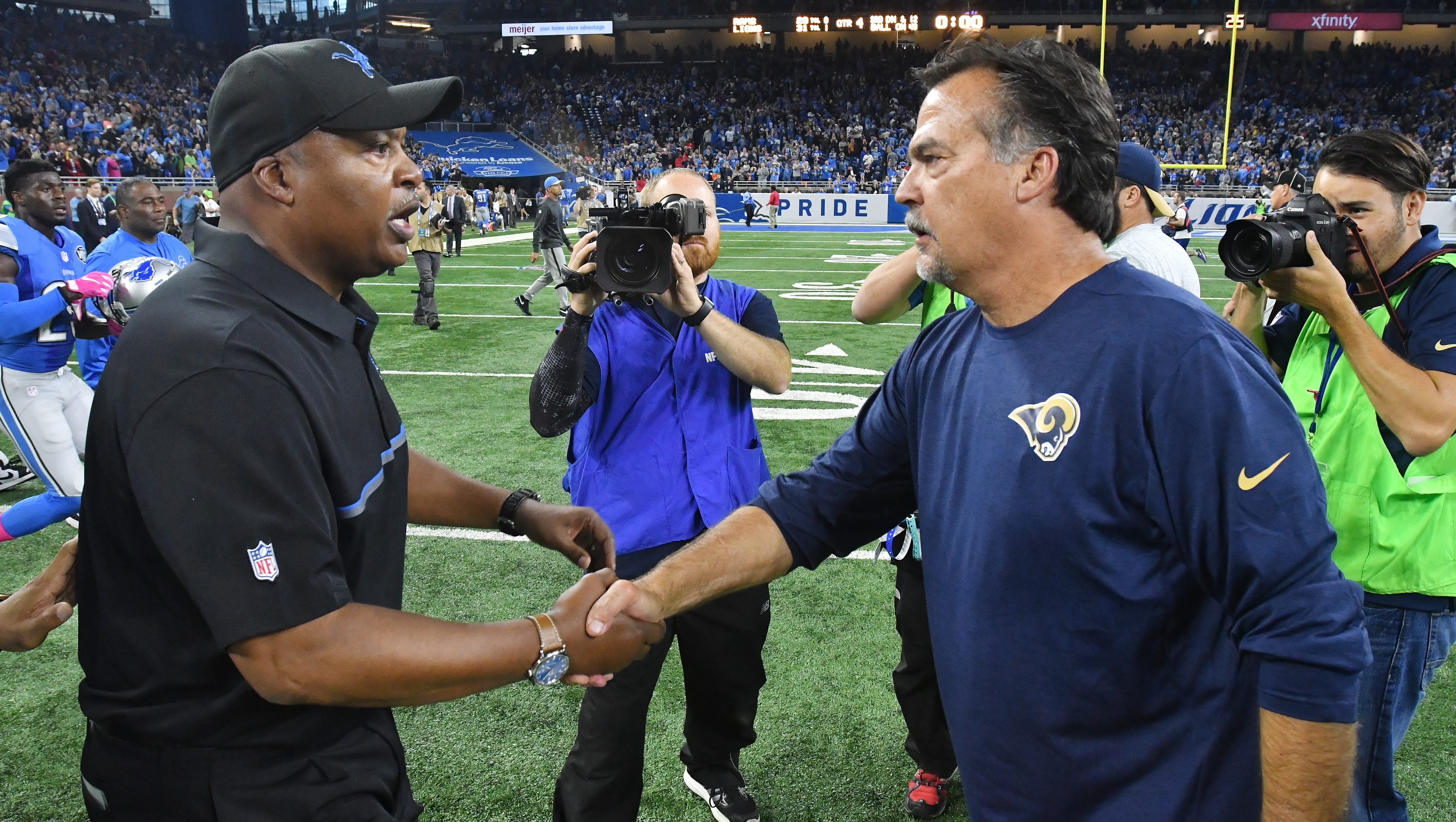 Lions head coach James Caldwell and Rams head coach Jeff Fisher meet on the field after the 31-28 Detroit victory.
