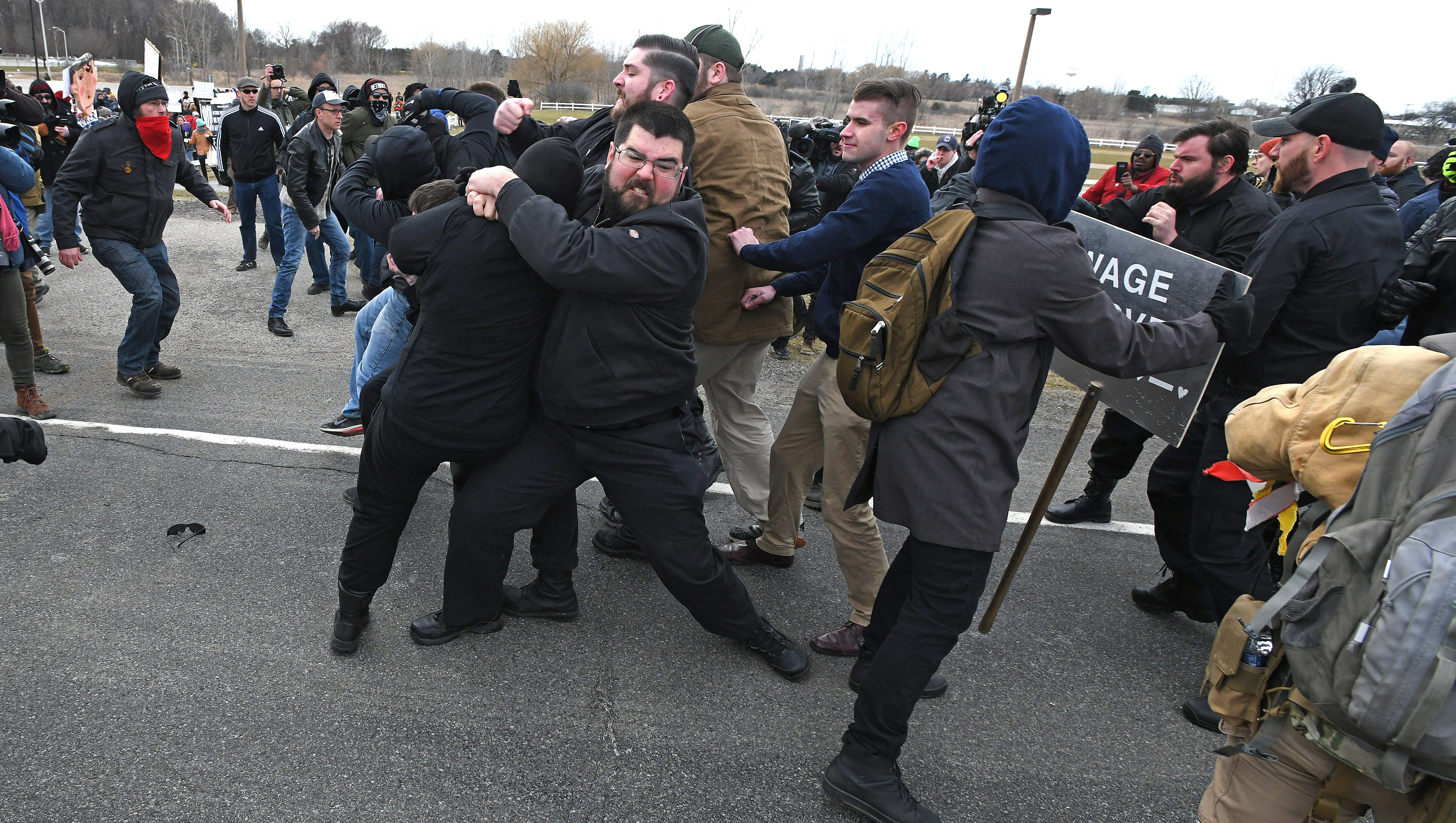 Matthew Heimbach, top, leader of the white nationalist Traditional Workers Party tackles a Richard Spencer protester.