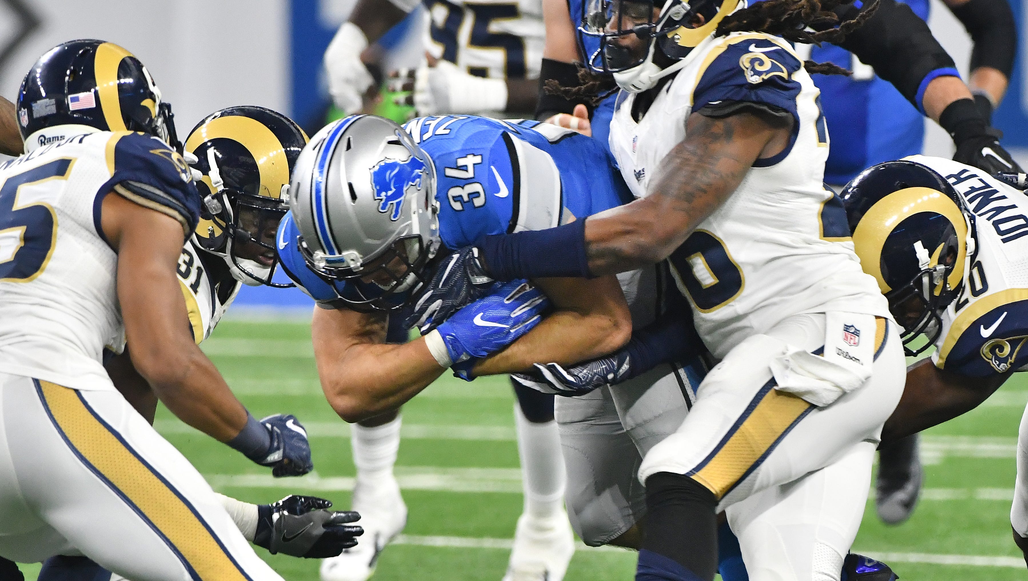 Lions running back Zach Zenner battles with the Rams defense on a gain in the fourth quarter.