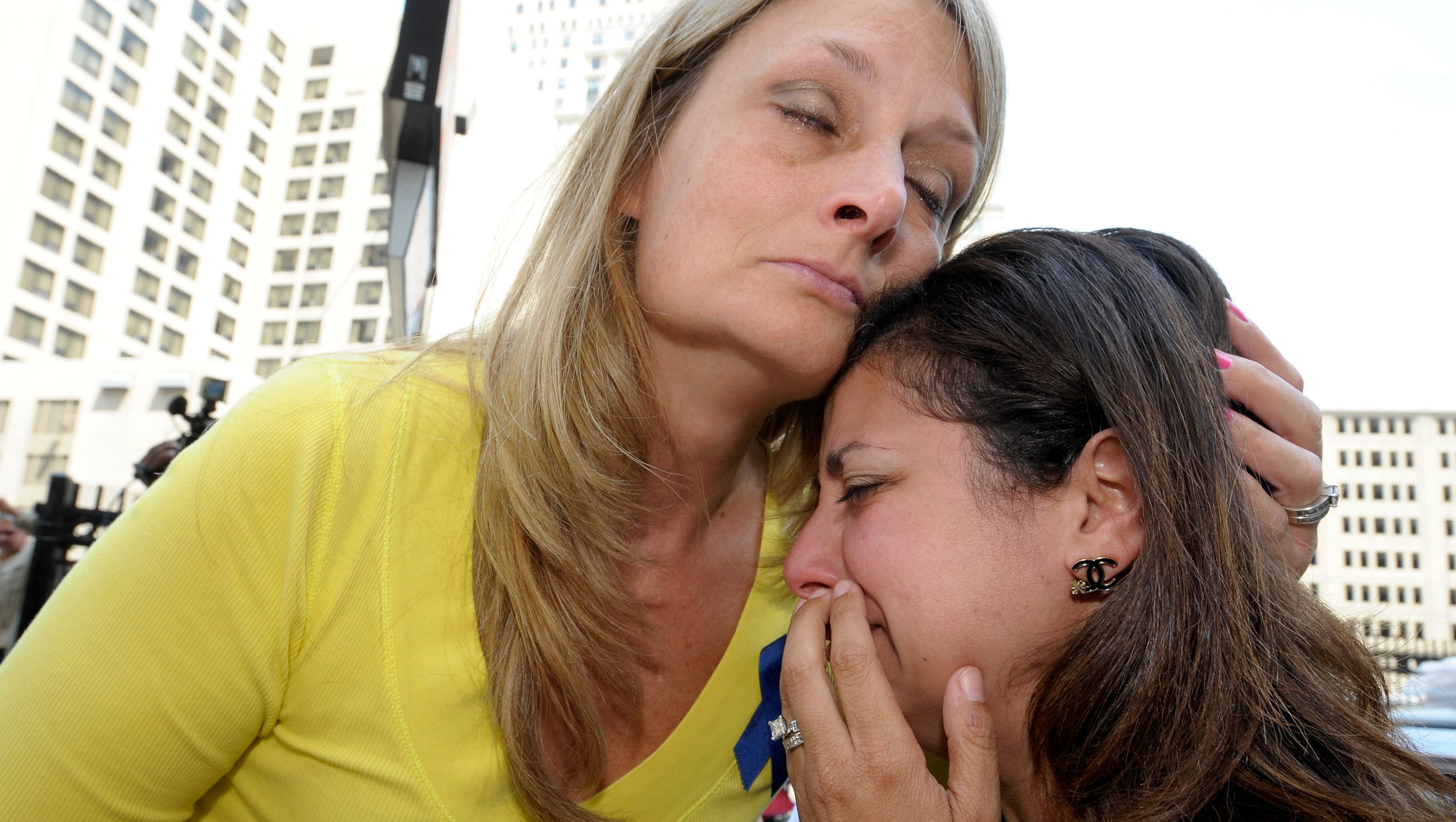 Cheryl Blades, left, of Waterford, hugs a woman who wishes not to be identified after the sentencing. The woman was treated by Fata while she was pregnant twice and is still treated for an unknown condition. Thus far, her children are healthy. Blades mother, Nancy LaFrance, died of lung cancer. Victims and the family members of victims are emotional as they leave the federal courthouse in Detroit, Friday afternoon, July 10, 2015, after they listen to the 45-year sentencing of Dr. Farid Fata for misdiagnosis of cancer and Medicare fraud.