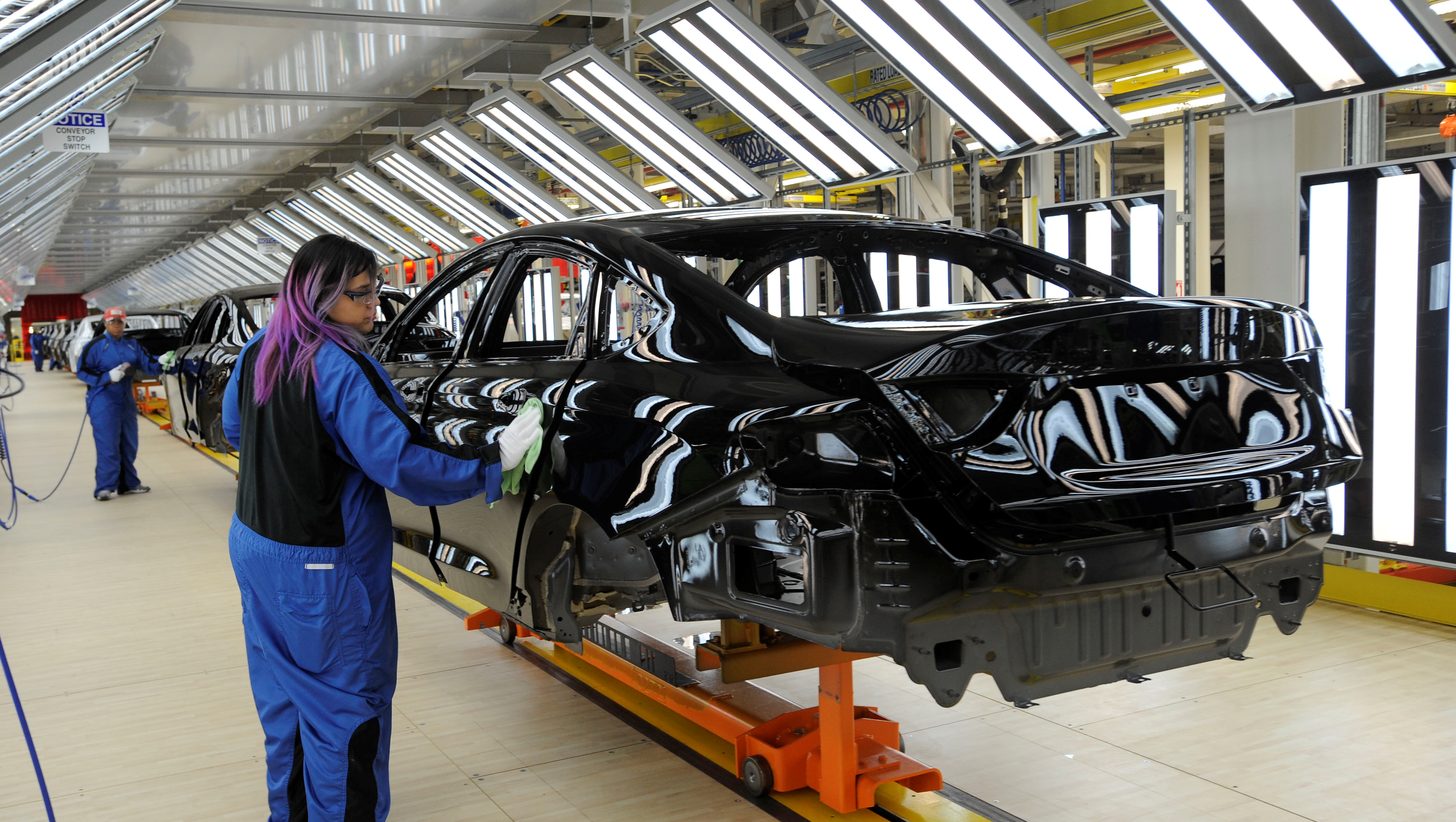 A 2015 Chrysler 200 glides through the paint shop at the Chrysler Sterling Heights Assembly Plant in Sterling Heights on March 14, 2014.