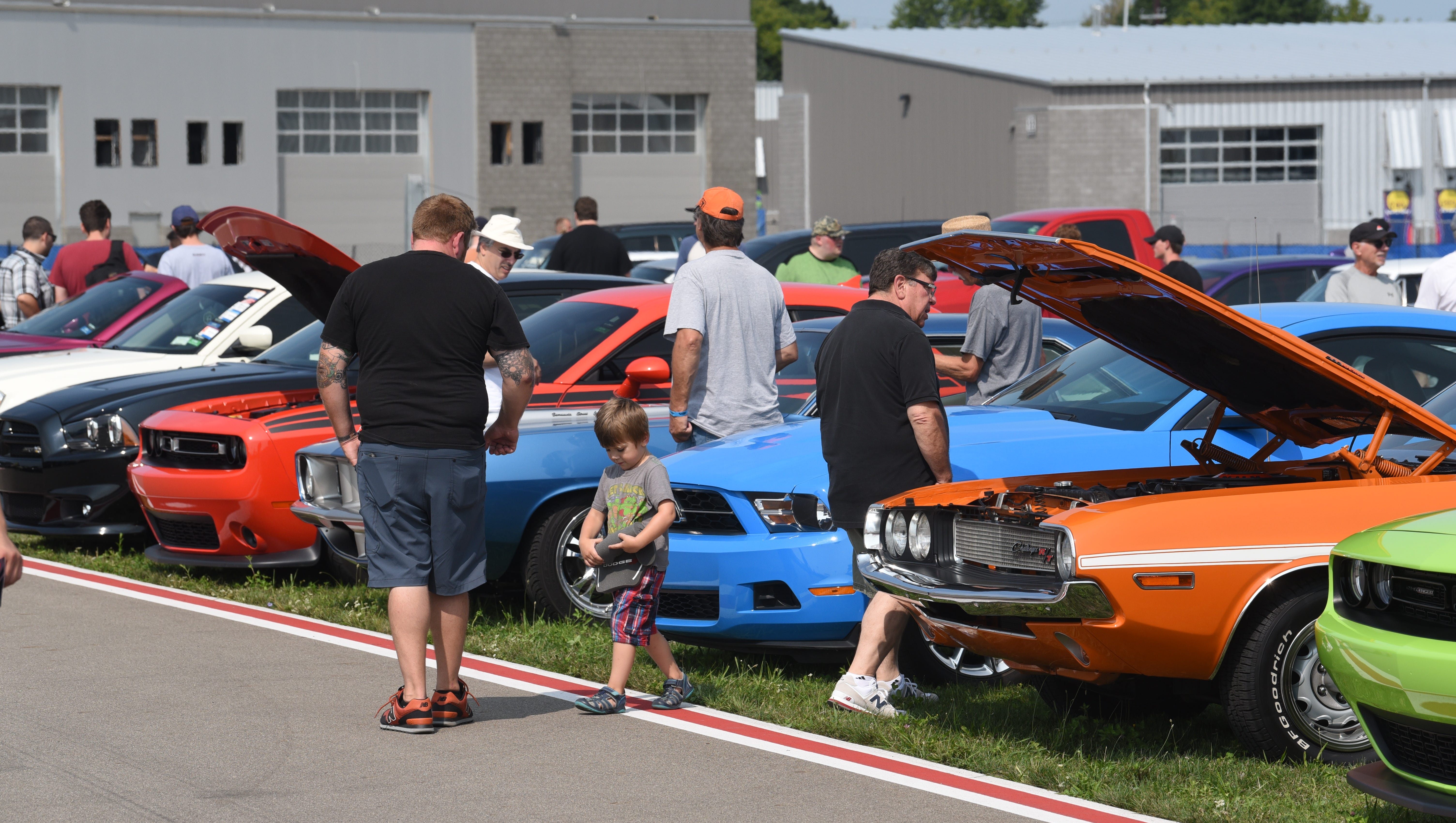 People enjoy the muscle cars on display during the Roadkill Nights event.