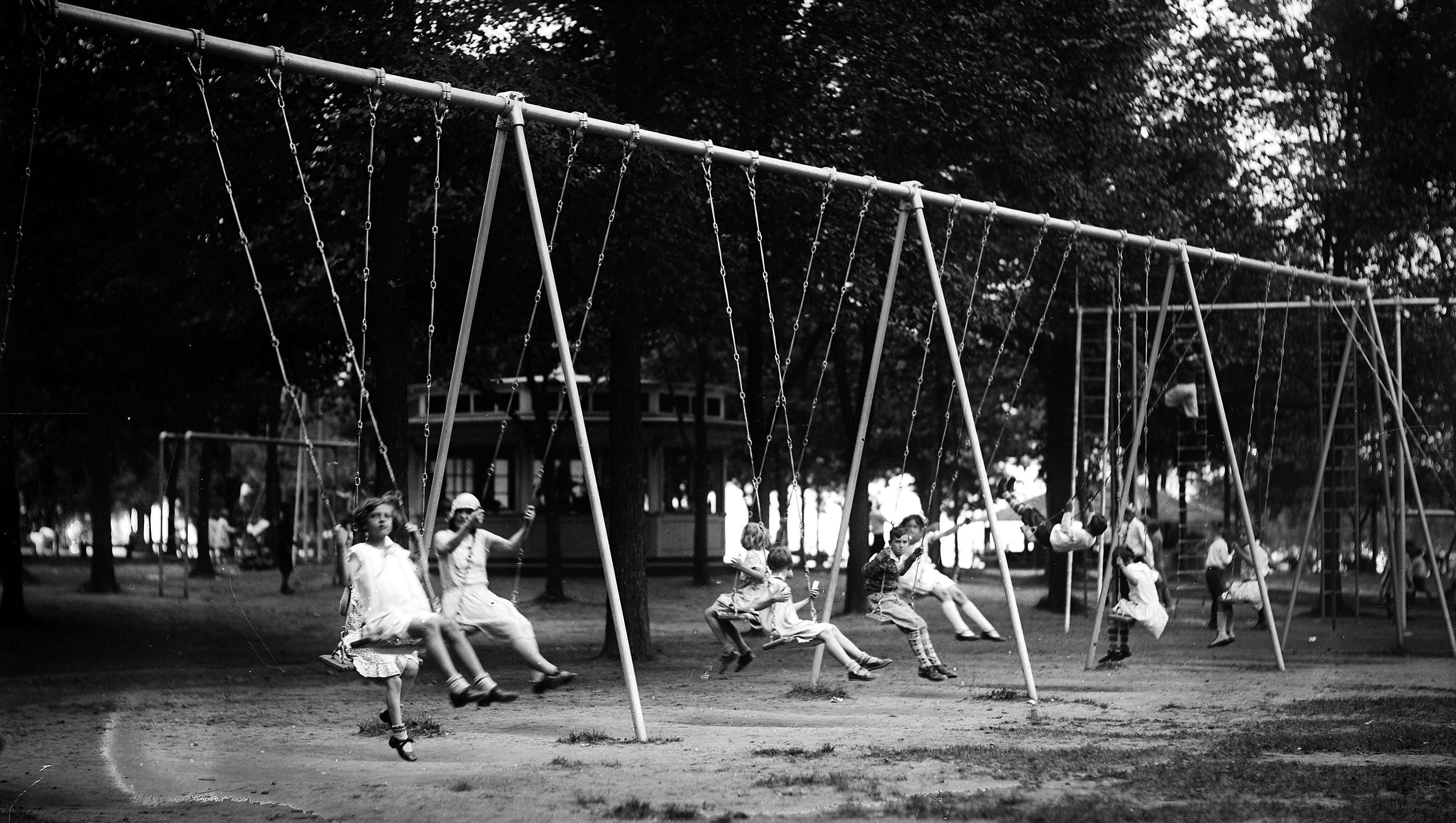 Children play on a swing set on Boblo Island in the 1920s.