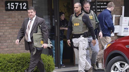 FBI agents leave the office of Dr. Fakhruddin Attar at the Burhani Medical Clinic in Livonia in February.