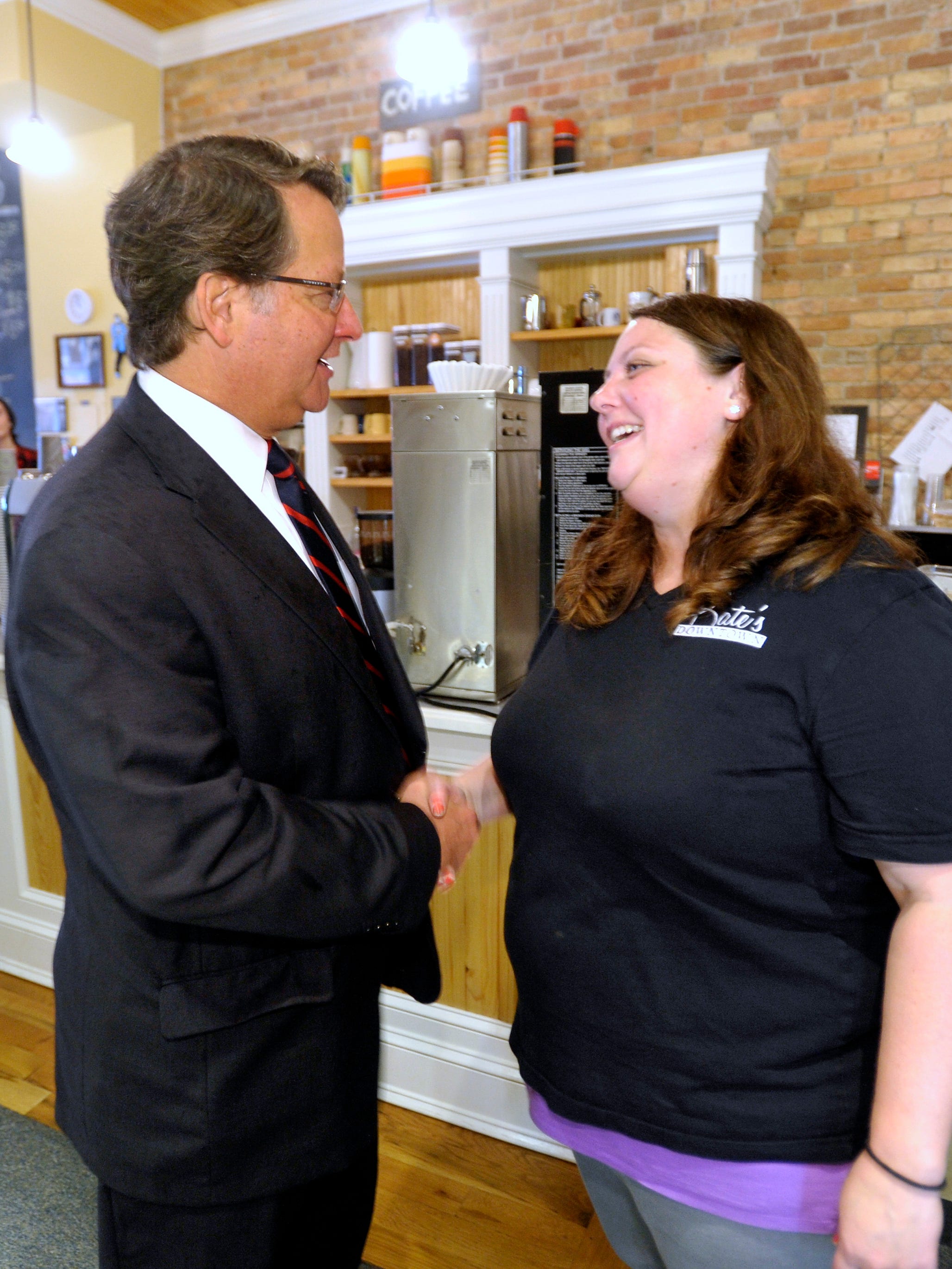 U.S. Congressman Gary Peters, left, talks with  Kate's Downtown owner Kate Voss, right, 35, of Port Huron, before Peters eats lunch at the Port Huron restaurant.