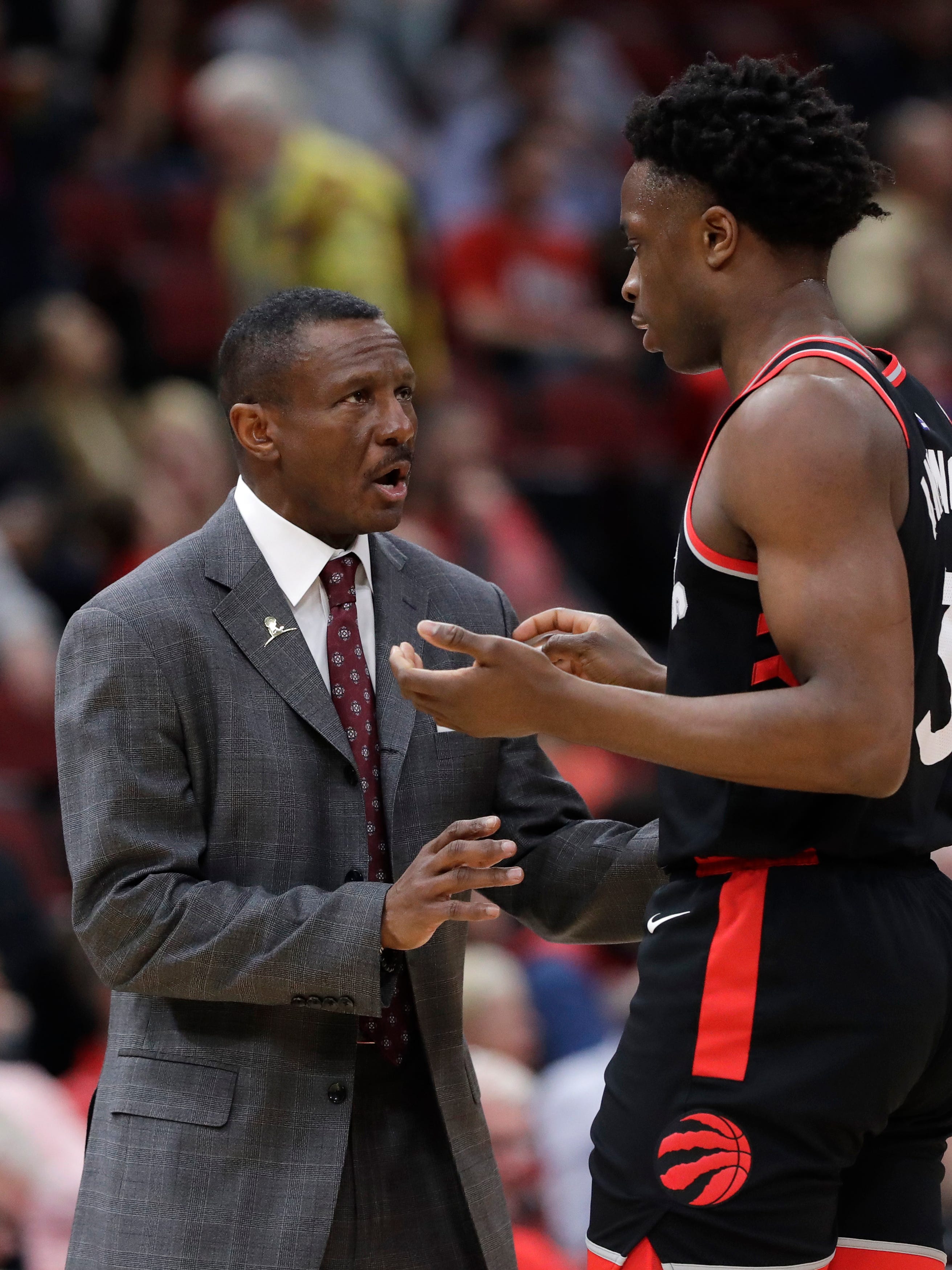 Toronto Raptors head coach Dwane Casey, left, talks with forward OG Anunoby during the first half of an NBA basketball game against the Chicago Bulls, Wednesday, Feb. 14, 2018, in Chicago.