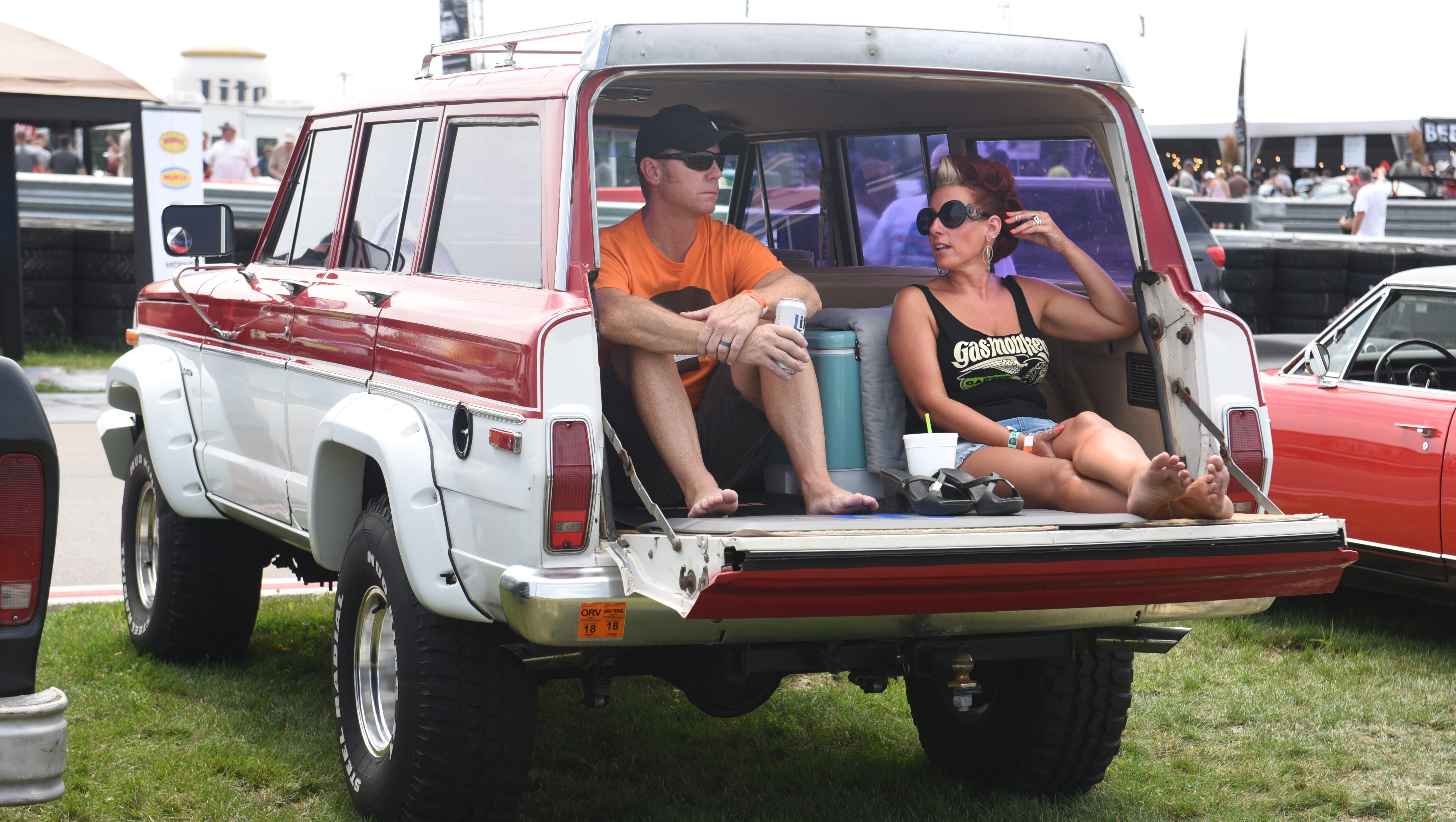Joe Cholewa (left) and Michelle Biebel, both of Lincoln Park, watch the Dodge drift rides  demonstration  from inside their 1983 Jeep Cherokee .