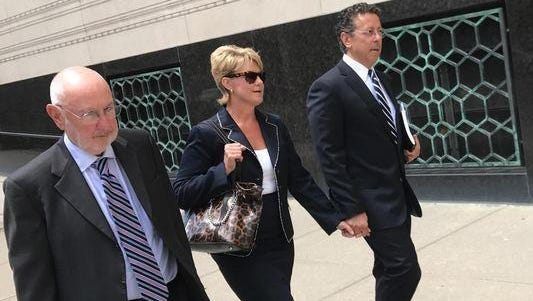 Alphons Iacobelli, far right, leaves the U.S. District Court in Detroit on Aug. 1, alongside Susanne Piwinski-Iacobelli and his lawyer, David DuMouchel, left.