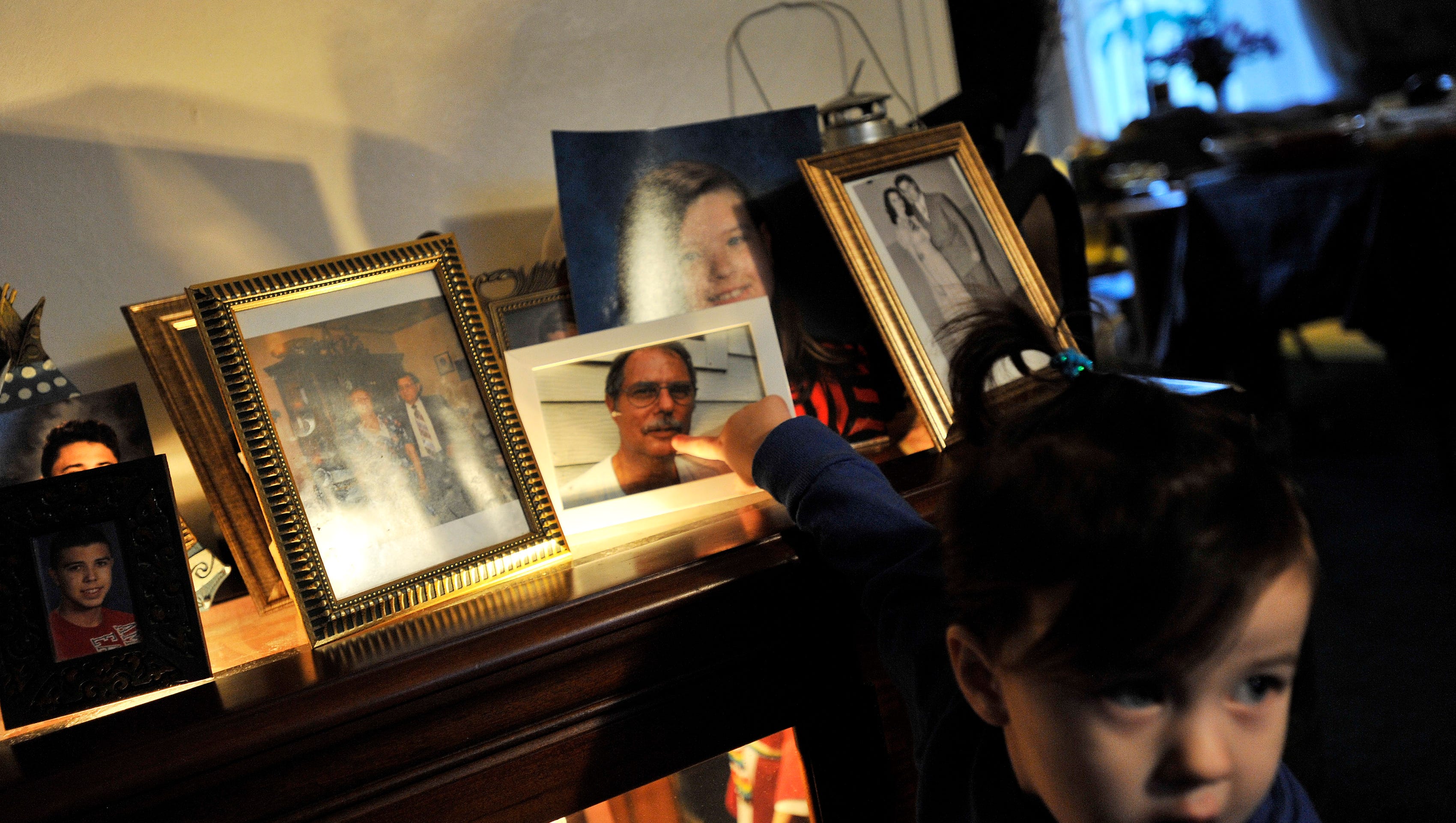 Layla Gutherie points to a photo of her grandfather, Chuck, who died of ALS last year.