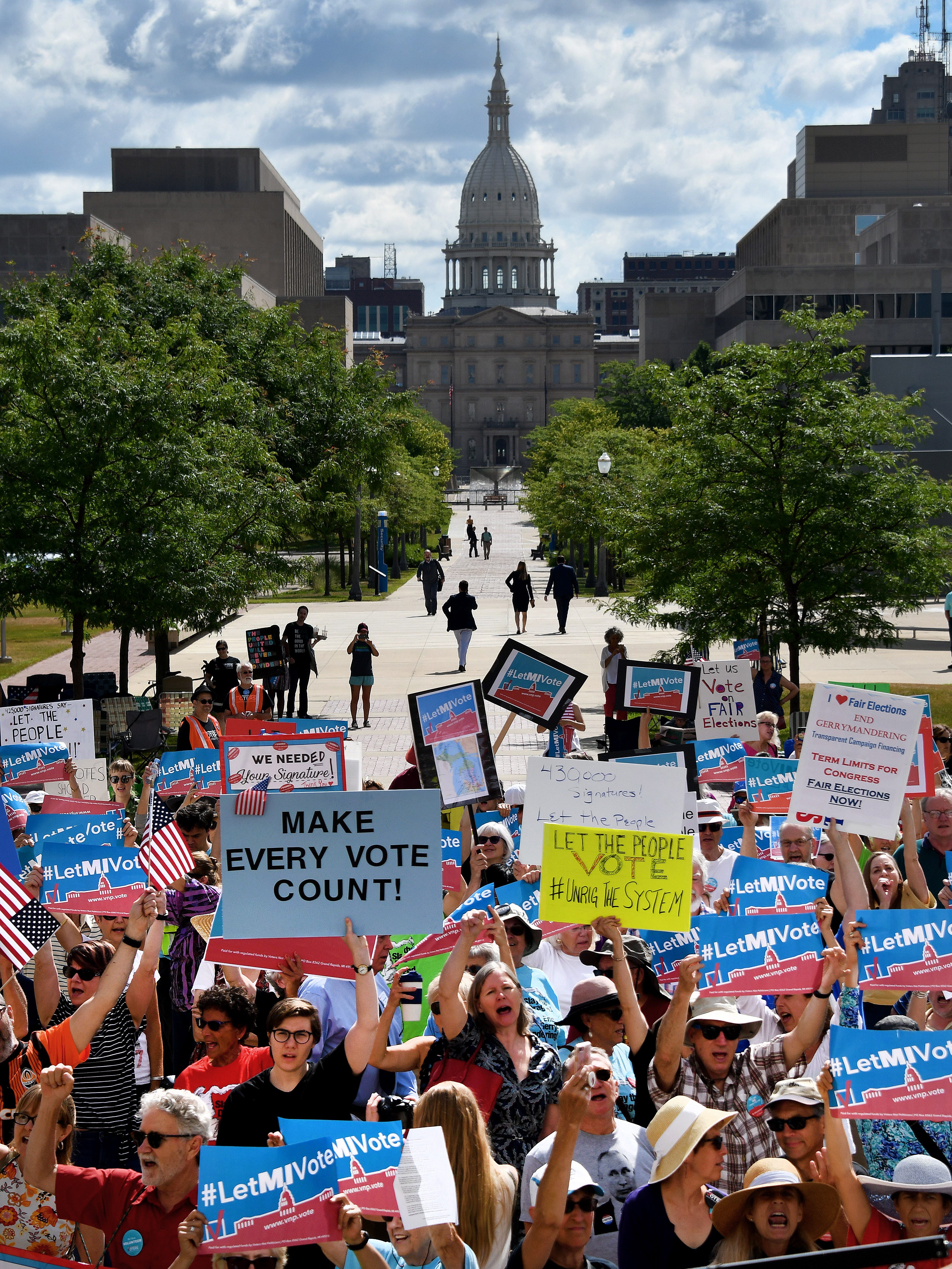 Over 100 demonstrators rally outside the Michigan Hall of Justice Wednesday, July 18, 2018, where the Michigan Supreme Court heard arguments on whether the constitution should be amended by voters to change the way political districts are made. The Capitol is visible in the background.