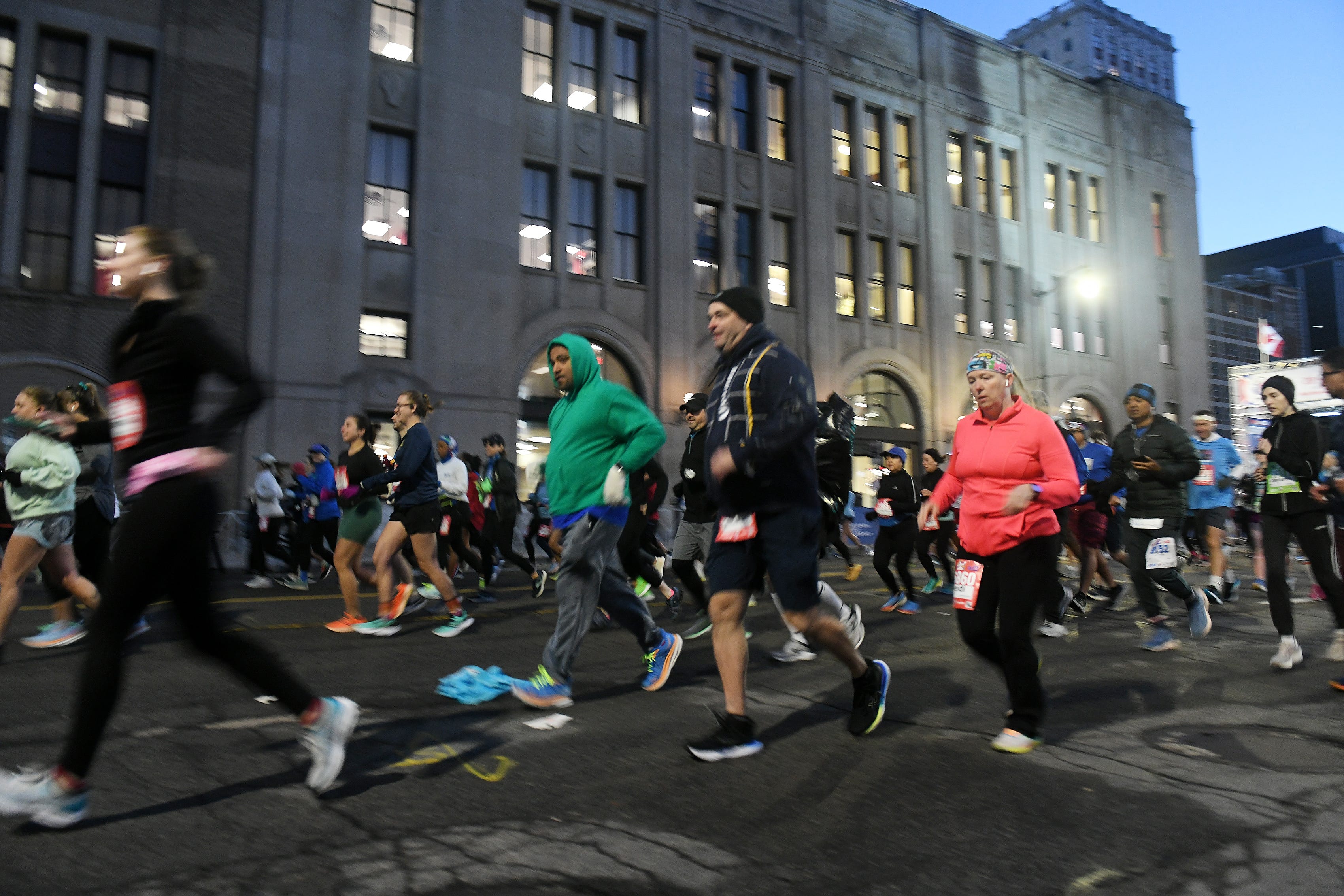 Runners in the second wave run down Fort Street at the start of the Detroit Free Press Marathon in Detroit on Oct. 15, 2023.