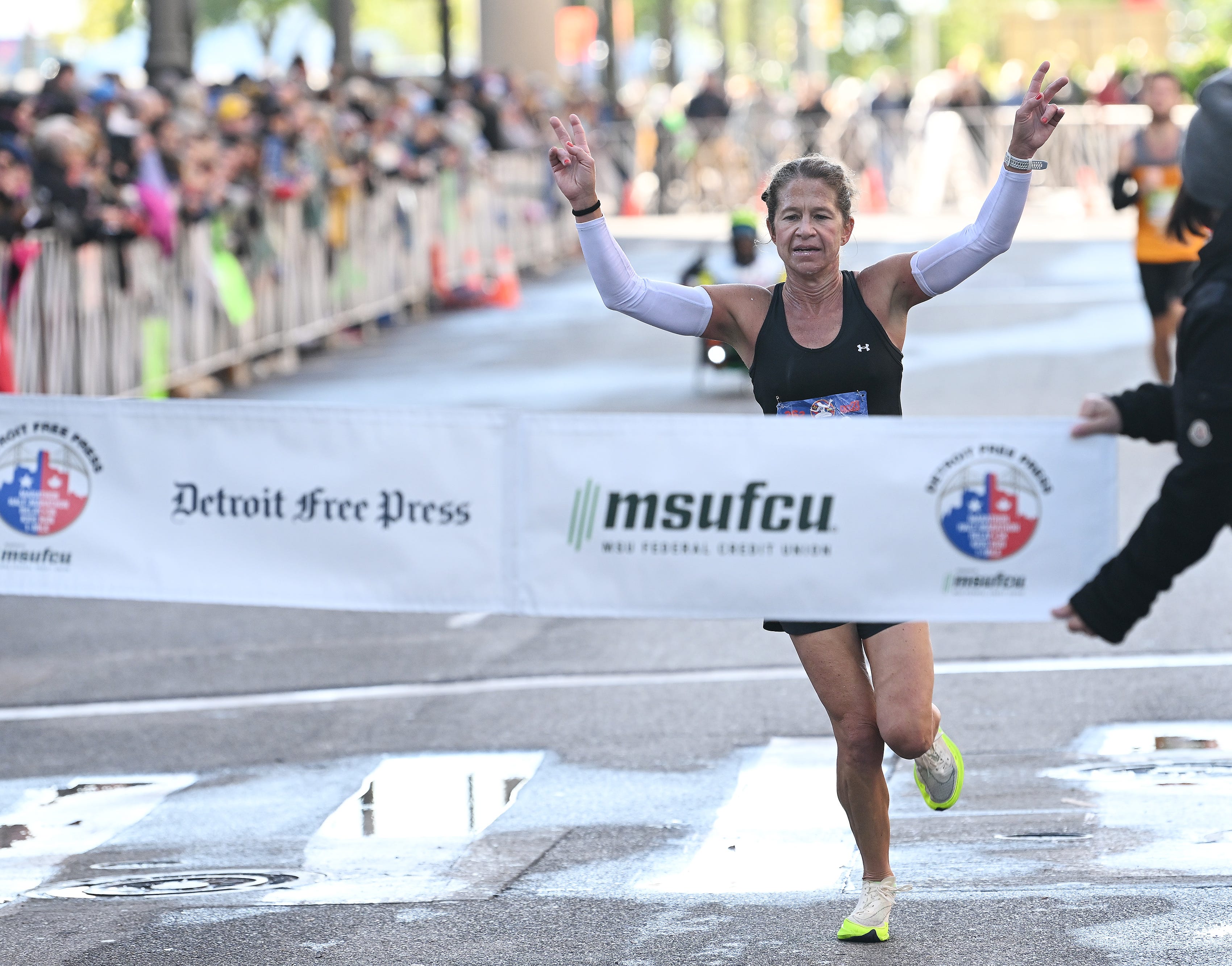 Kate Landau, 47, of Tacoma reacts as she is about to win the women’s division overall at the Detroit Free Press Marathon in Detroit on Oct. 15, 2023.
