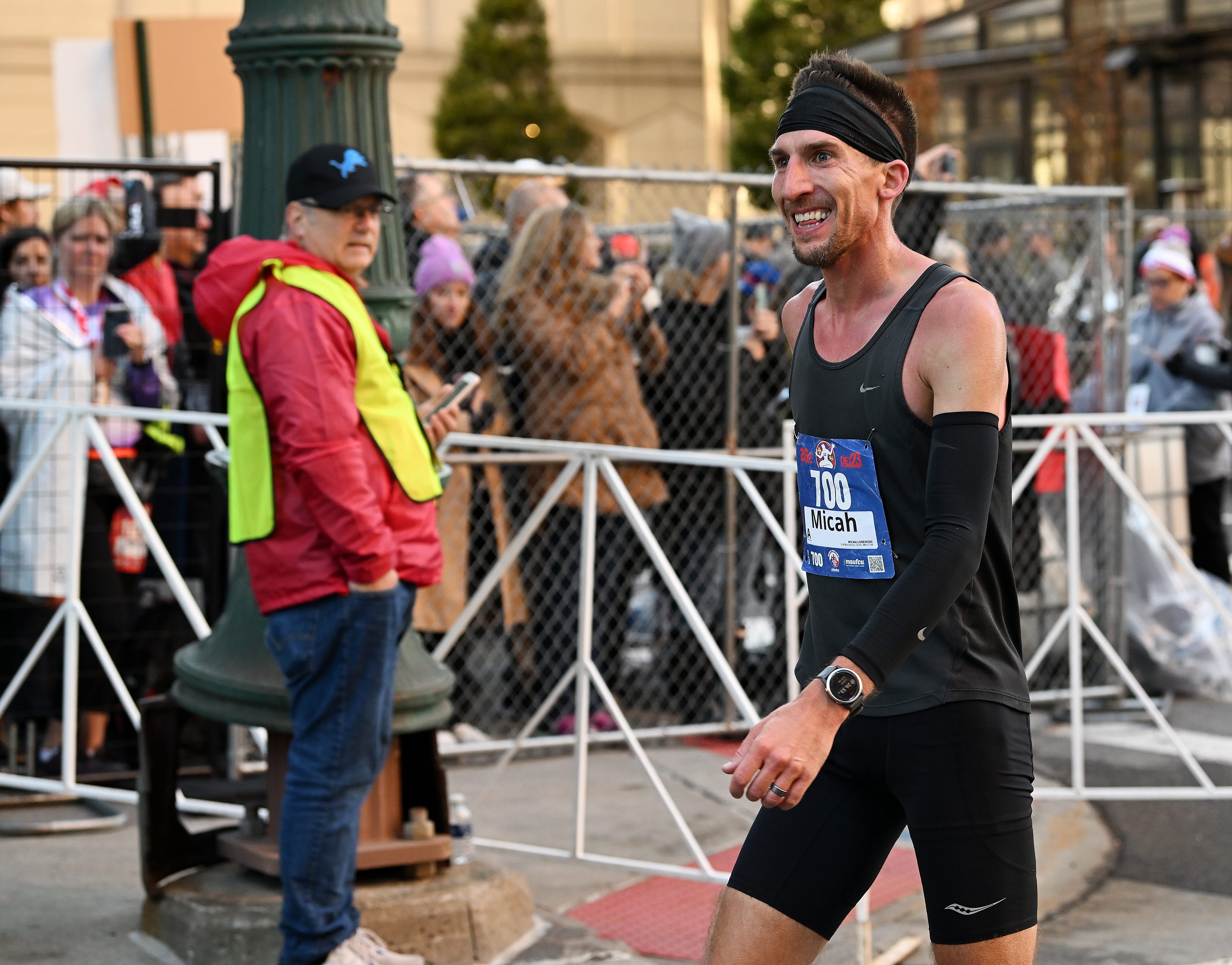 Micah Lorenzen, 37, of Livonia smiles after he finished fourth overall at the Detroit Free Press Marathon in Detroit on Oct. 15, 2023.