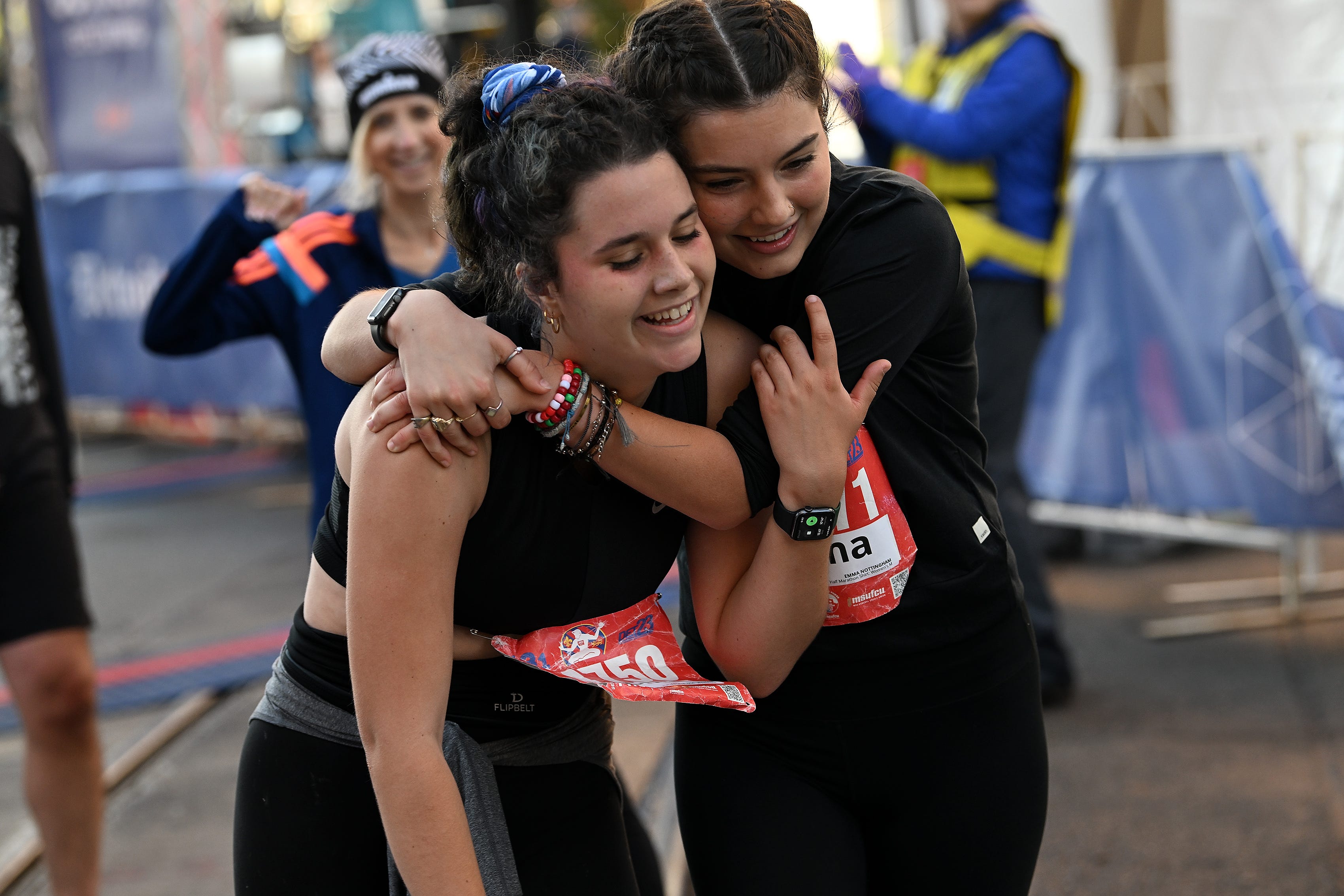 From left, Jennifer Diemert, 29, of Clawson and Emma Nottingham, 22, of Missouri react after they finish the half marathon.