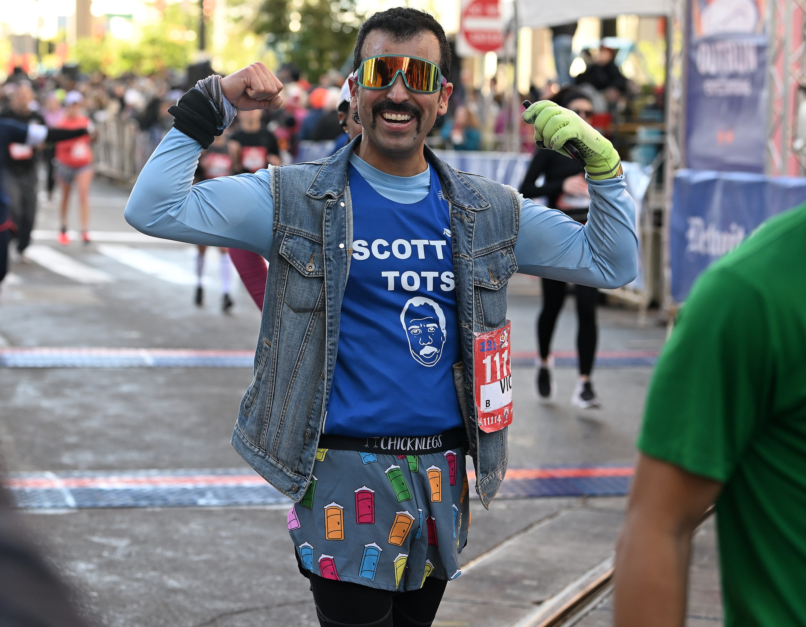Victor Rojas Rodriguez, 39, of Westland reacts after finishing the half marathon.