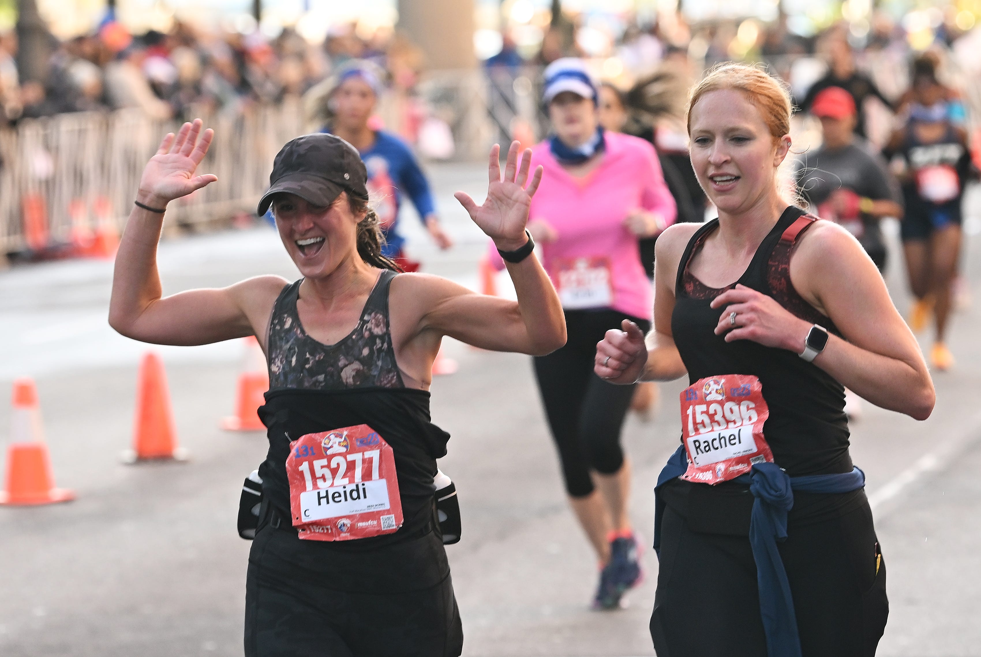 From left, Heidi Morris, 41, and Rachel Friesen, 33, both of Rochester Hills, react as they finish the half marathon.