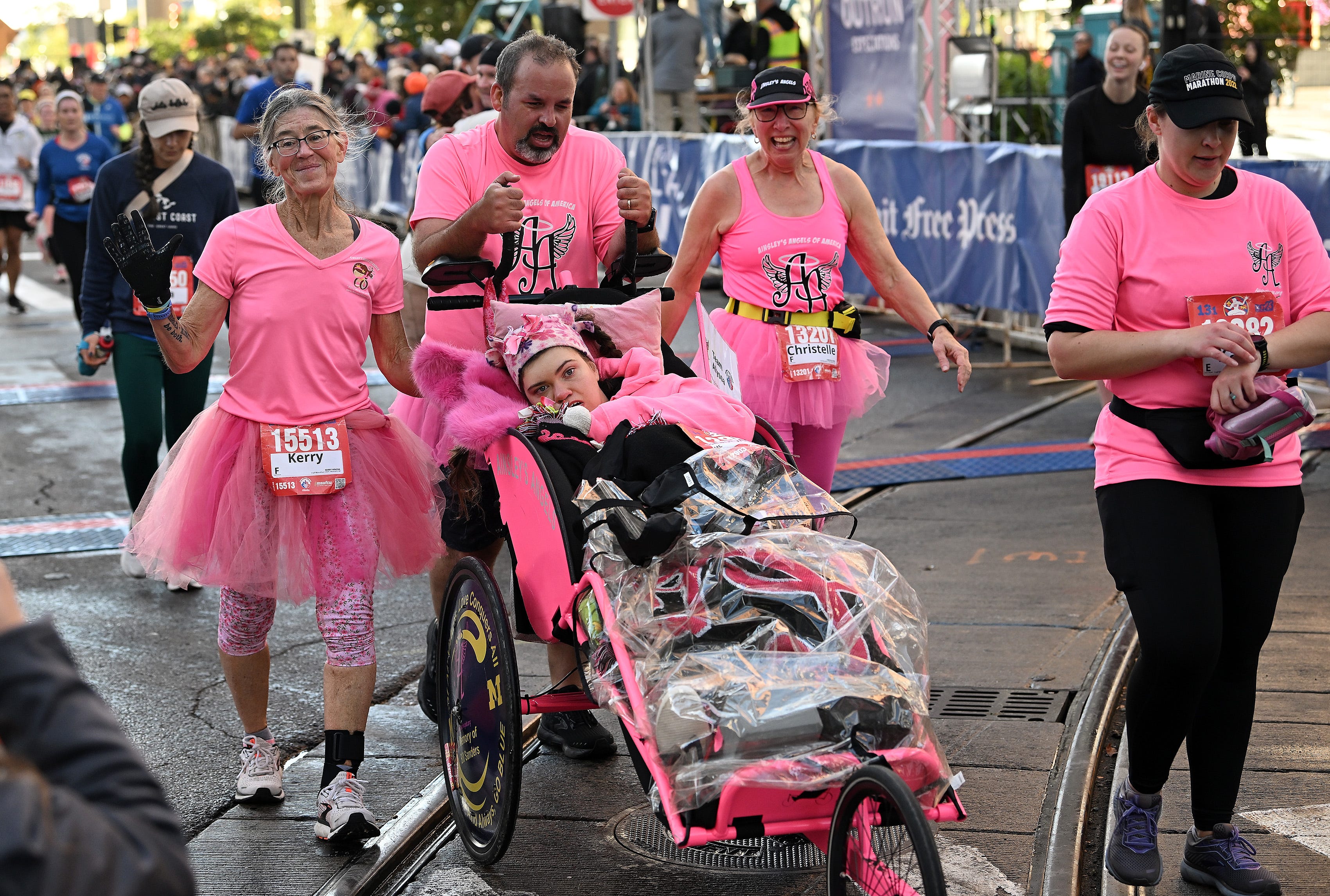 From left, Ainsley’s Angels team Kerry Hincka, 61, of Brighton, PJ Sapienza of Howell, Christelle Ross, 61, of Brighton and Katherine Pawlik, 35, of Howell are the team doing the half marathon with Alyssa Feiler, in the roller, at the Detroit Free Press Marathon in Detroit on Oct. 15, 2023. 
(Robin Buckson / The Detroit News)