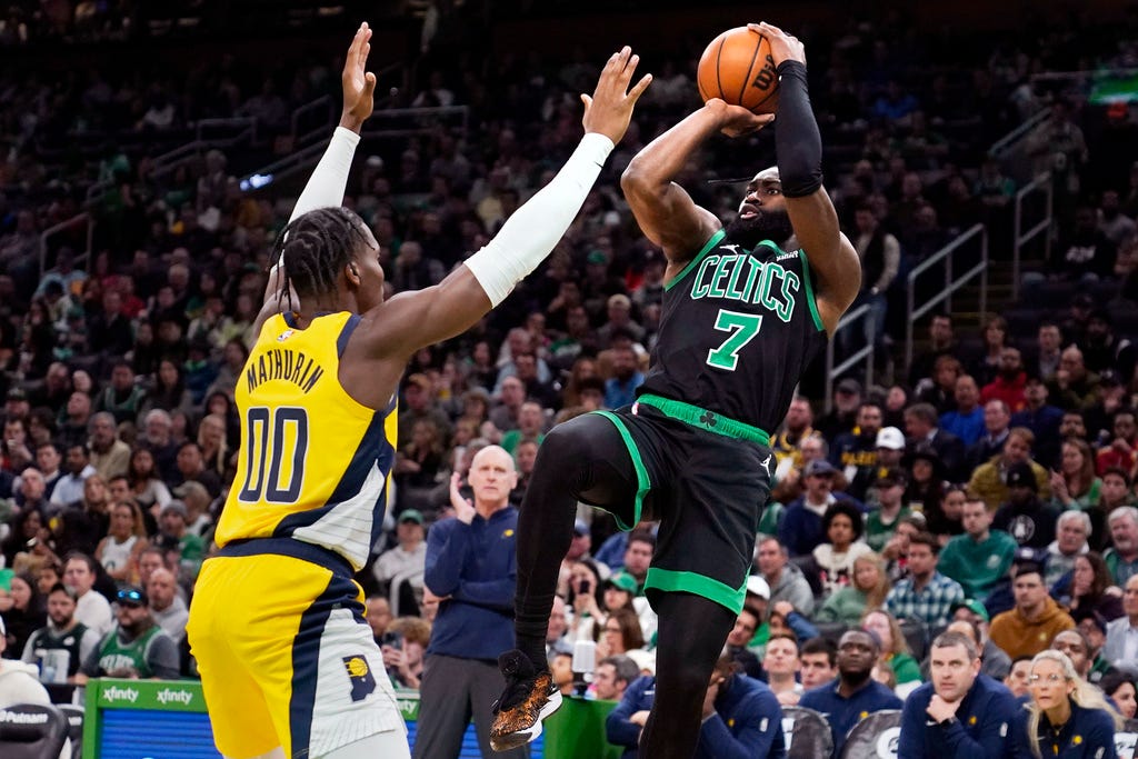 Celtics guard Jaylen Brown (7) shoots over Pacers guard Bennedict Mathurin (00) during the second half of Wednesday's game in Boston.