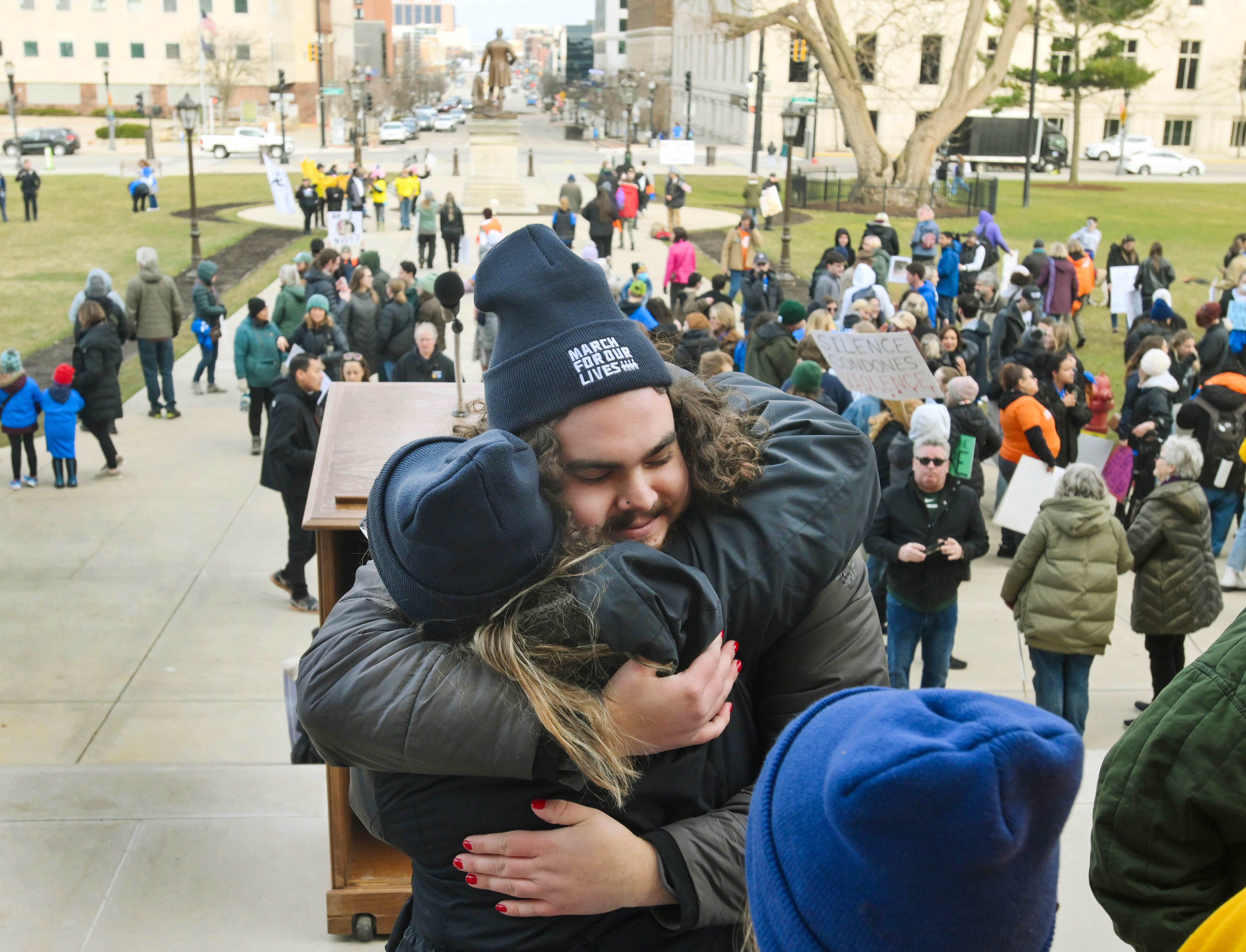 Student Troy Forbush, who was wounded in the Michigan State shooting, gets hugs from other speakers after the March for Our Lives rally for the five-year anniversary of the Parkland, Florida high school shooting in Lansing on March 23, 2023.