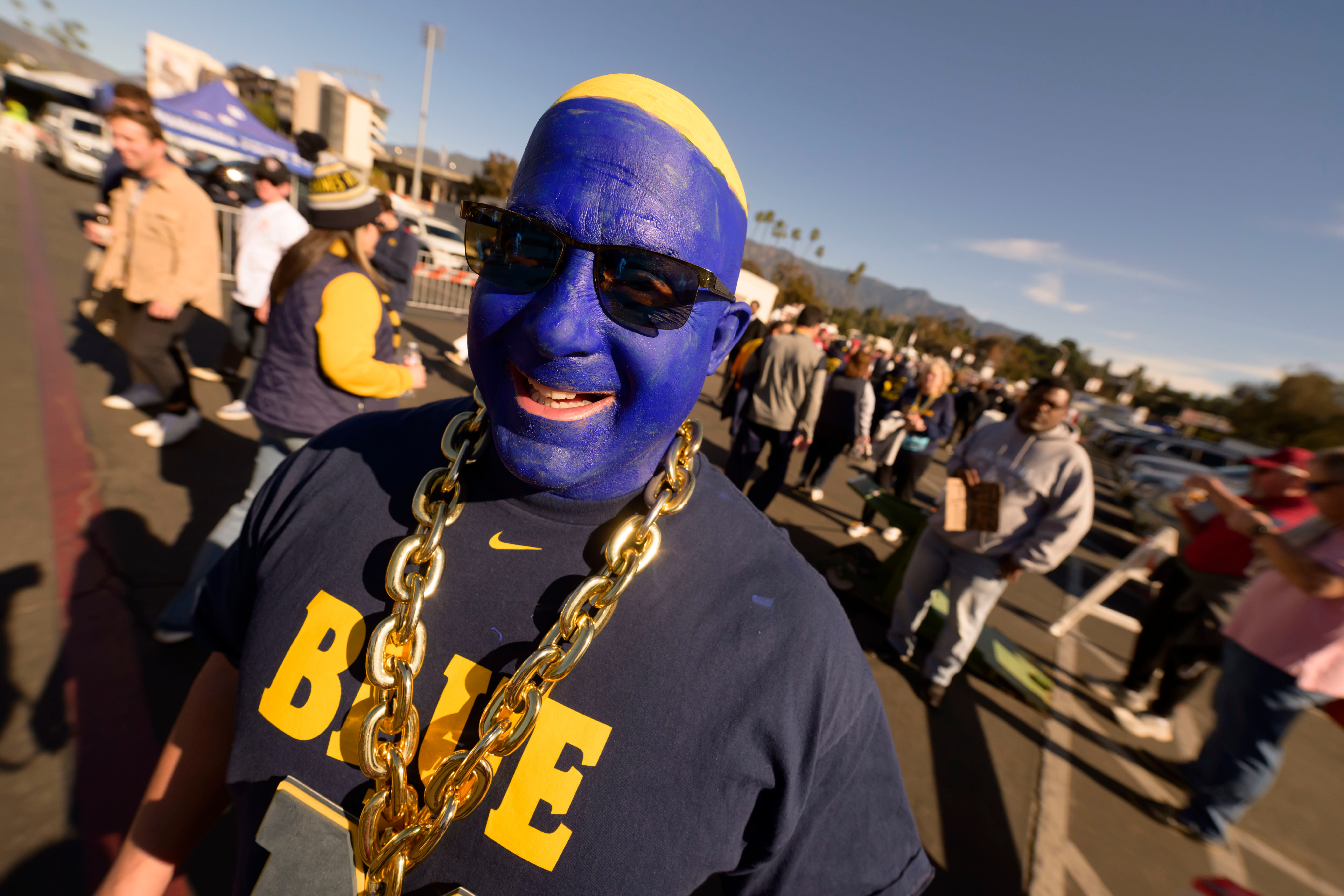 Detroit native Martin Sacco, now living in Pensacola, Florida, wears blue face paint while wandering around before the start of the Rose Bowl, in Pasadena, California, on Jan. 1, 2024.