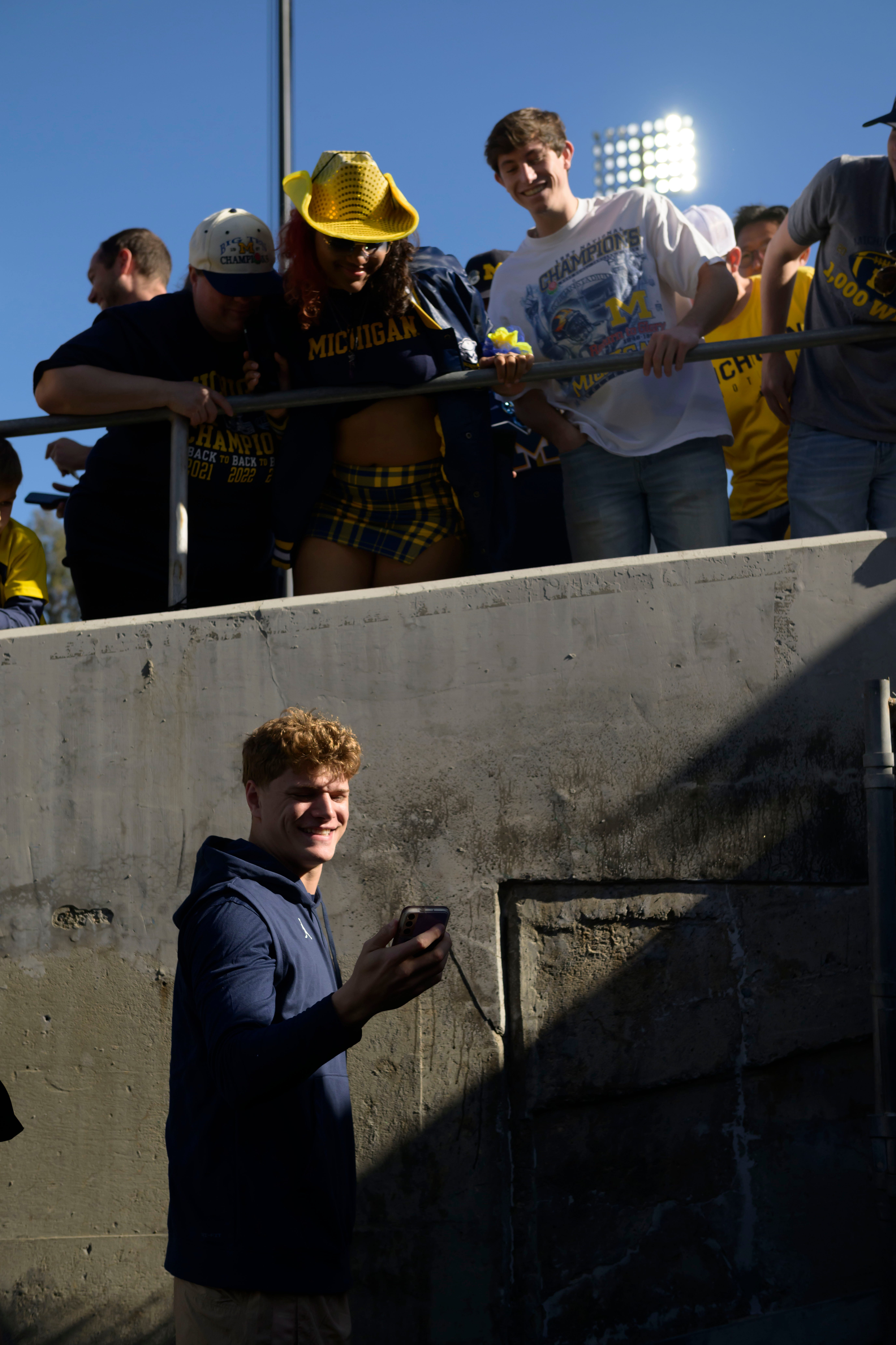Michigan quarterback J.J. McCarthy takes a selfie with the fans before the start of the Rose Bowl, in Pasadena, California, on Jan. 1, 2024.