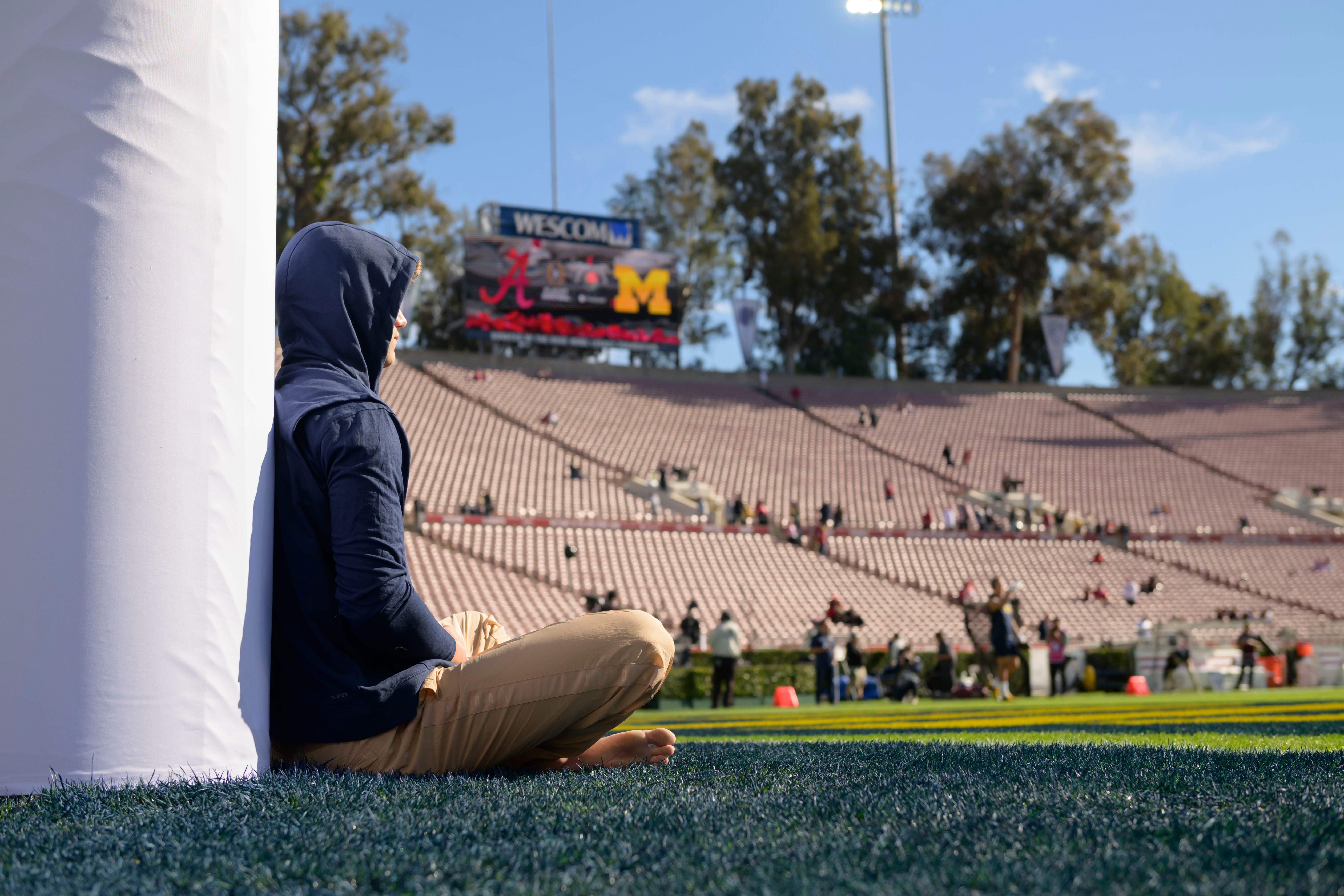 Michigan quarterback J.J. McCarthy meditates on the field before the start of the Rose Bowl, in Pasadena, California, on Jan. 1, 2024.
