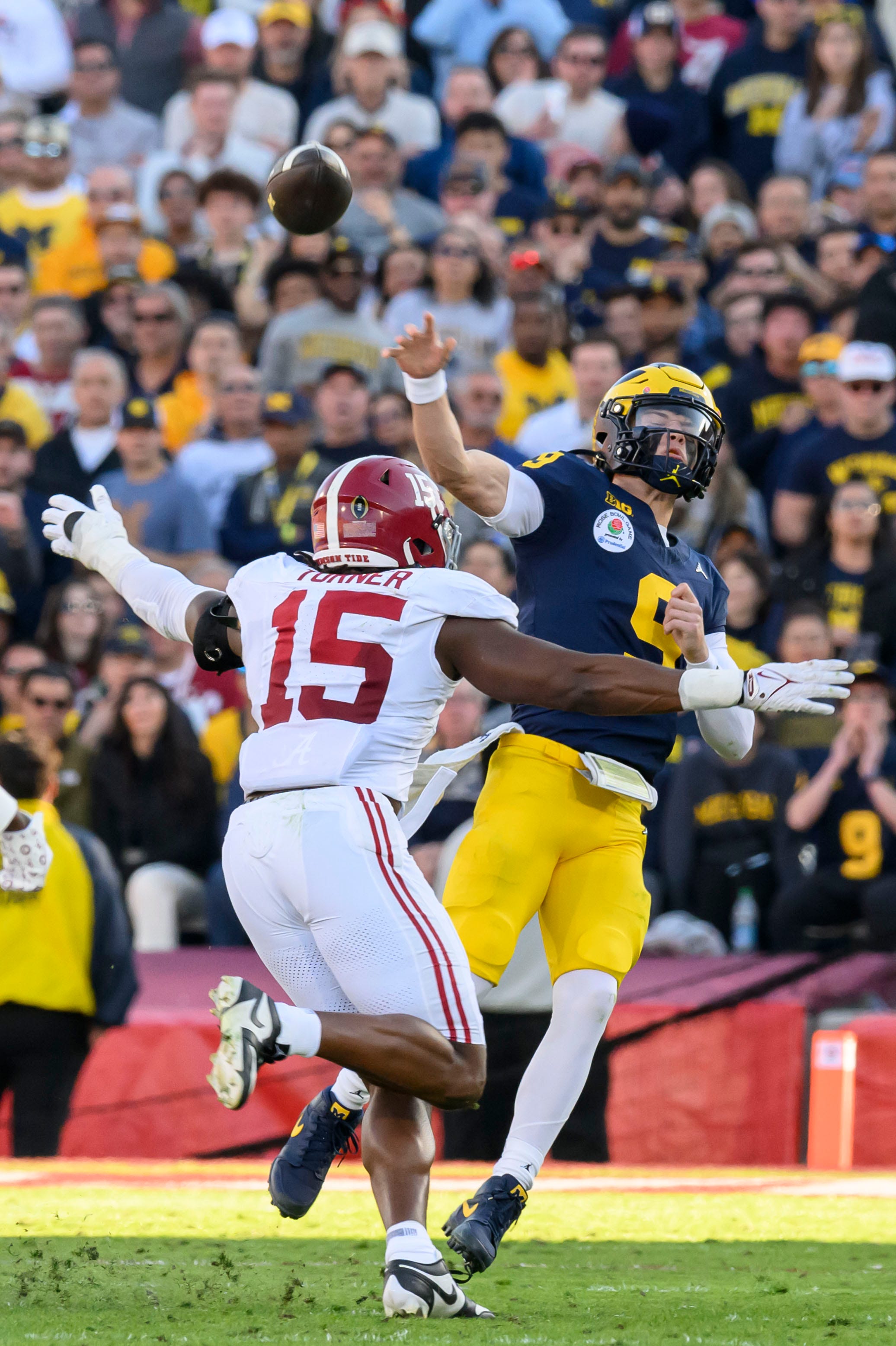 Michigan quarterback J.J. McCarthy unleashes a pass before being hit by Alabama linebacker Dallas Turner during the second quarter of the Rose Bowl, in Pasadena, California, January 1, 2024.