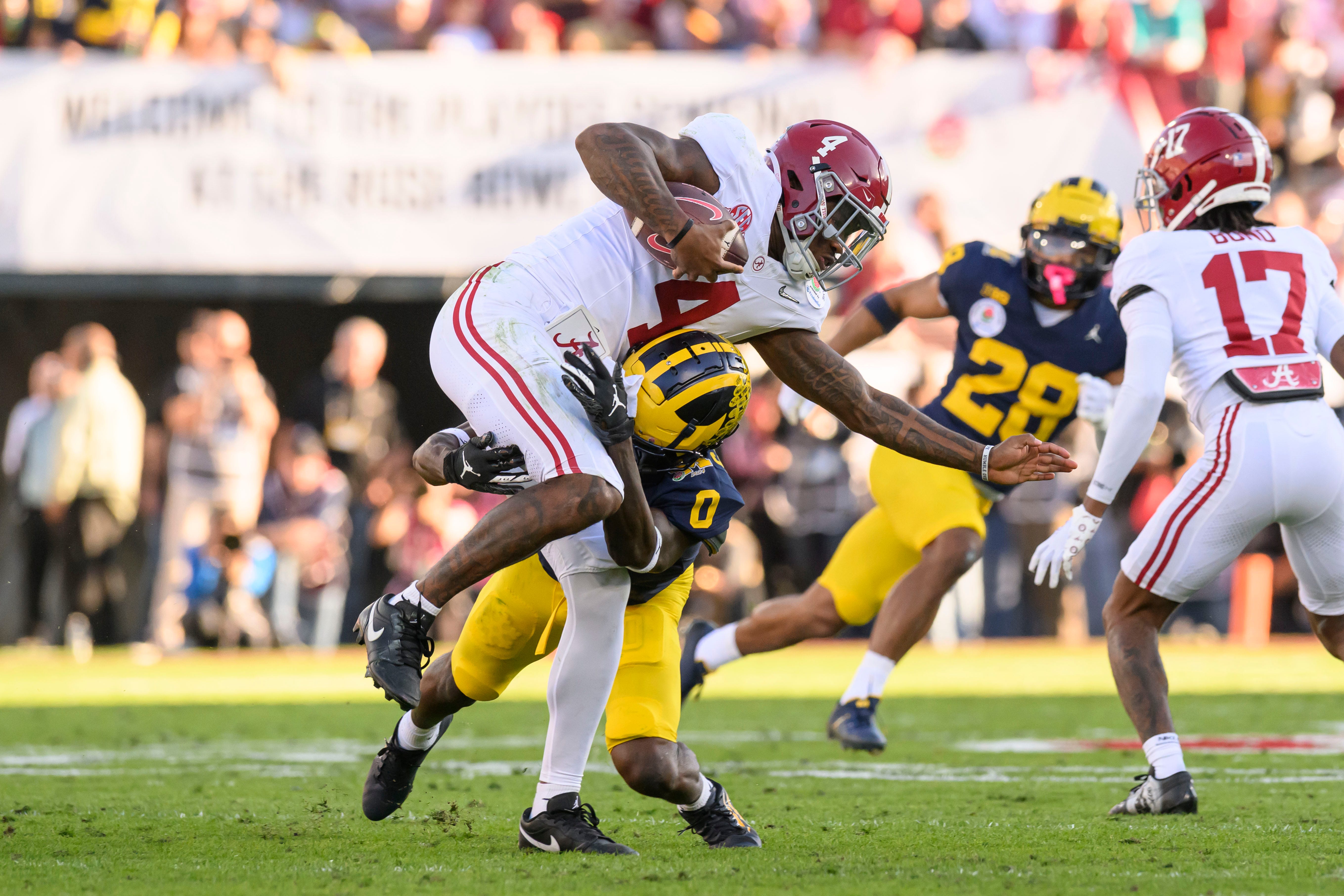 Michigan defensive back Mike Sainristil tackles Alabama quarterback Jalen Milroe and keeps Milroe from making a first down during the second quarter of the Rose Bowl, in Pasadena, California, January 1, 2024.