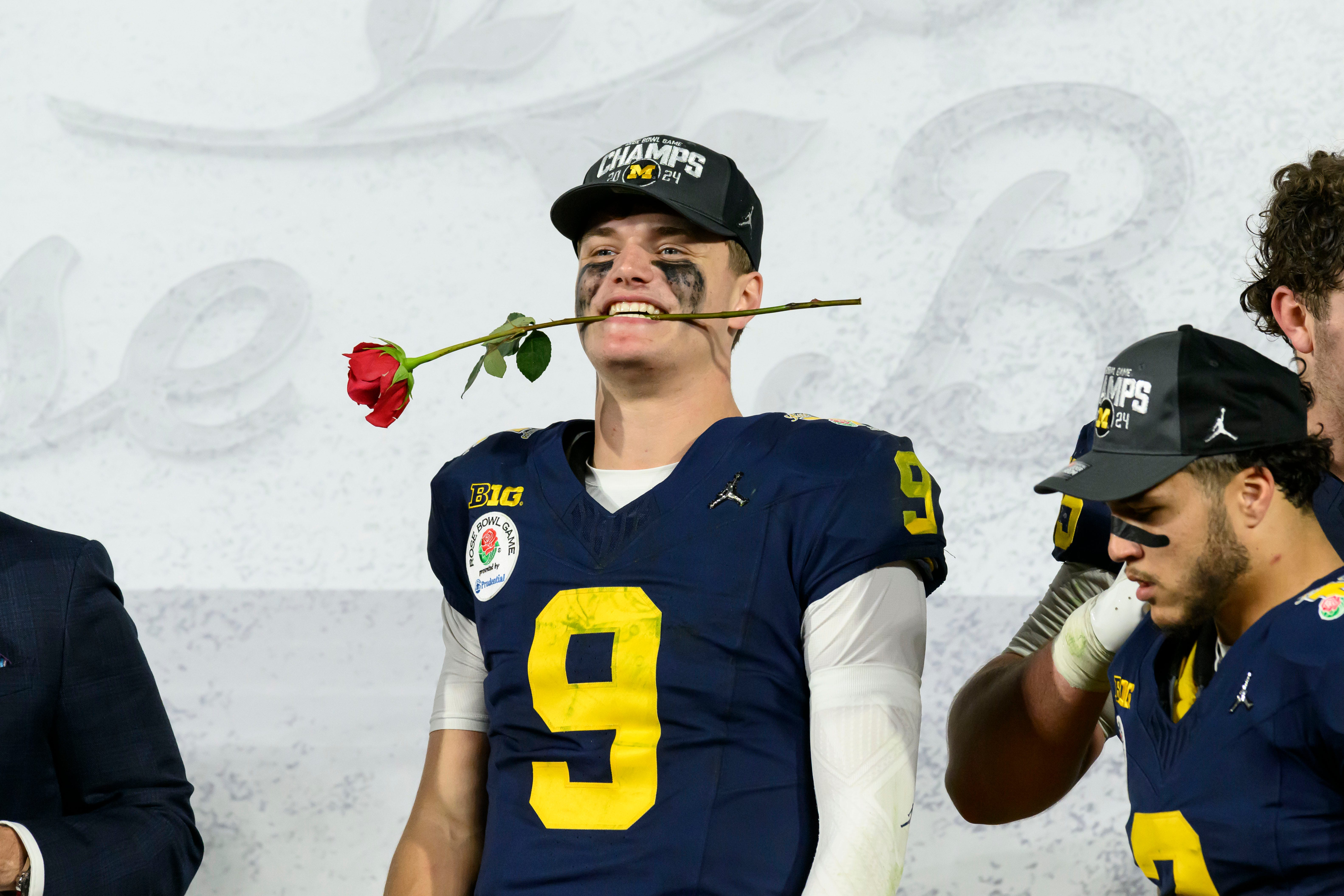 Michigan quarterback J.J. McCarthy sticks a rose in his mouth after the University of Michigan defeated Alabama University 27-20 in overtime at the Rose Bowl, in Pasadena, California, January 1, 2024.