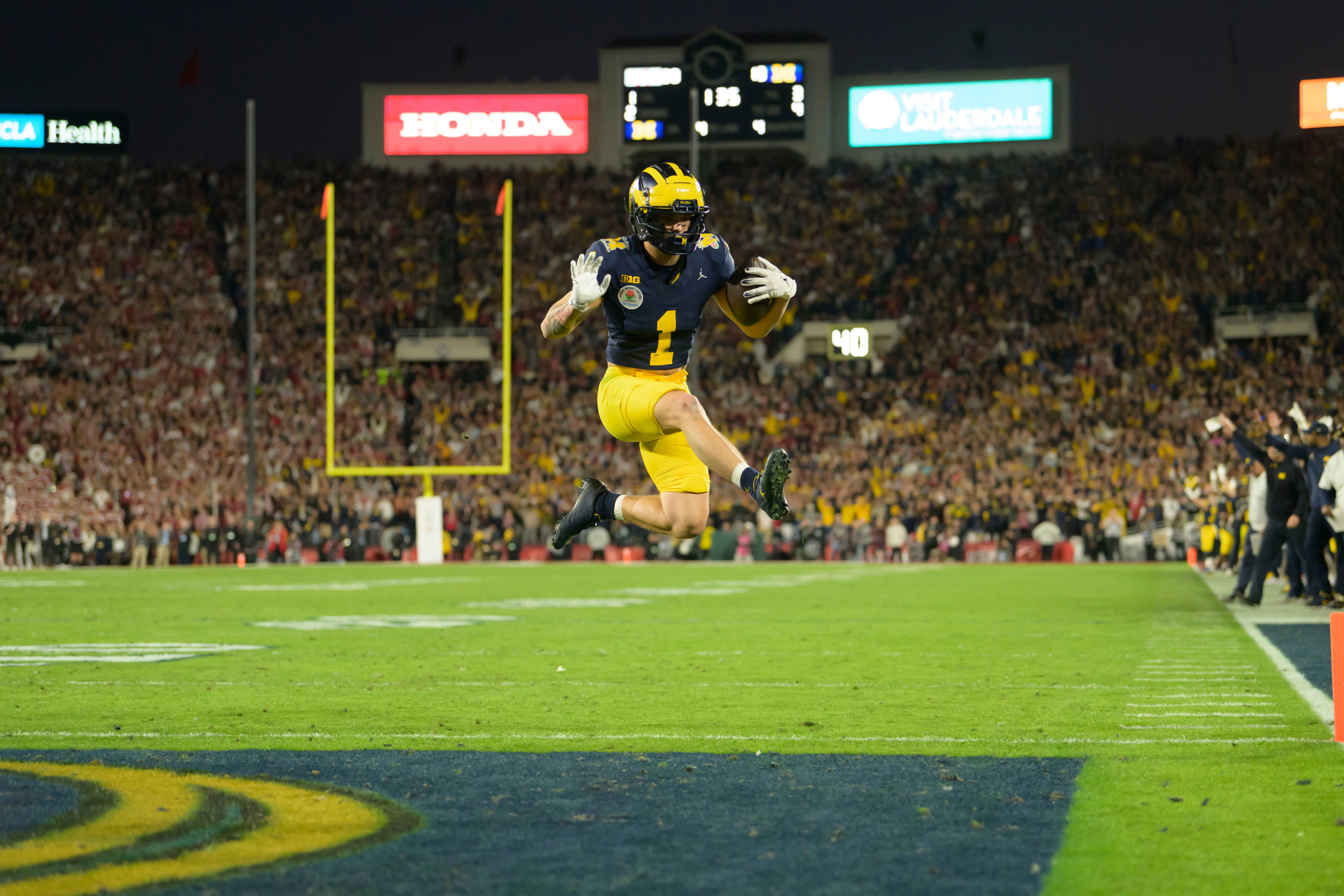 Michigan wide receiver Roman Wilson leaps into the end zone to score a touchdown late during the fourth quarter of the Rose Bowl, in Pasadena, California, January 1, 2024.