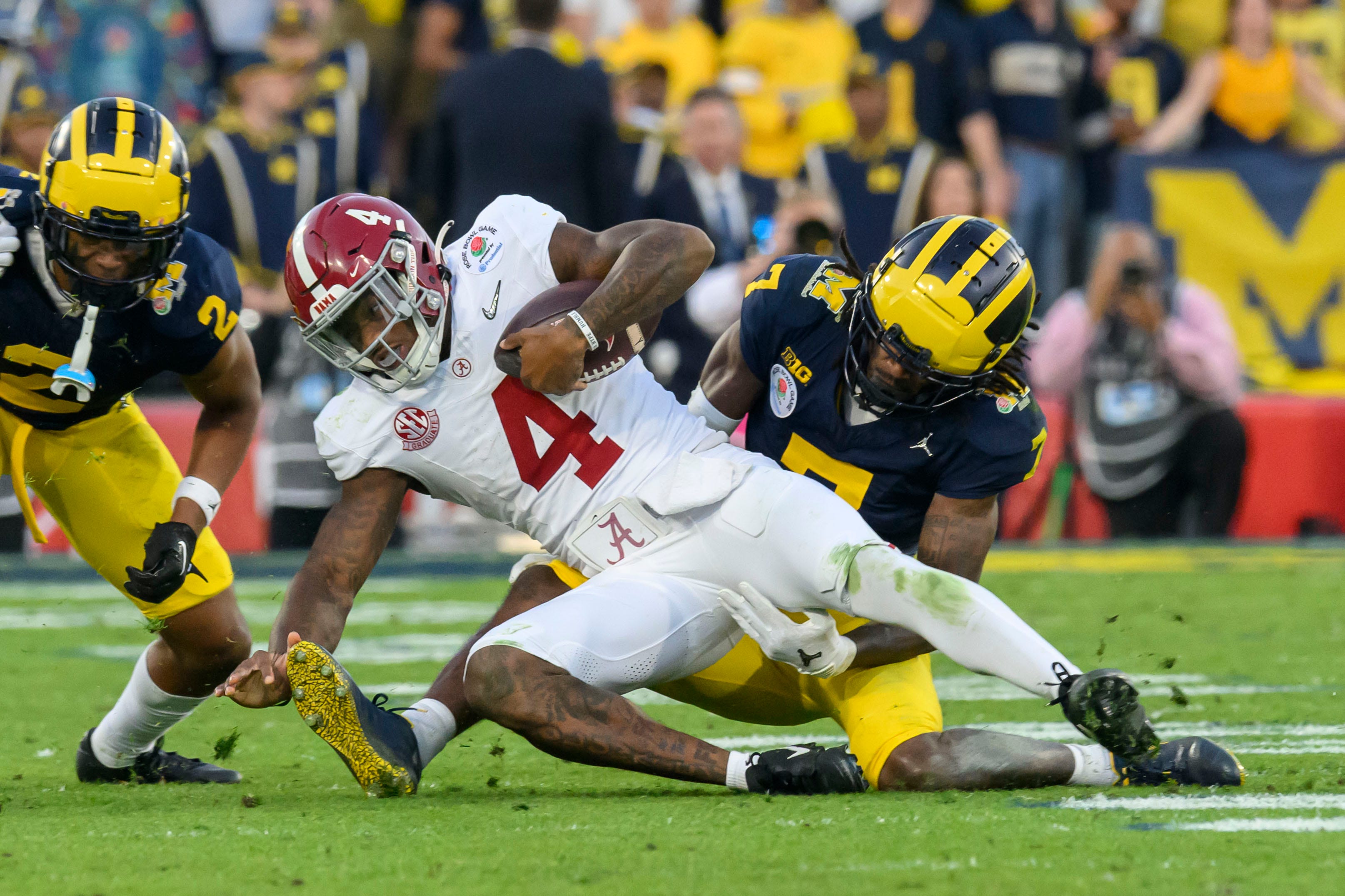 Alabama quarterback Jalen Milroe is tackled by Michigan defensive back Makari Paige during the third quarter of the Rose Bowl, in Pasadena, California, January 1, 2024.