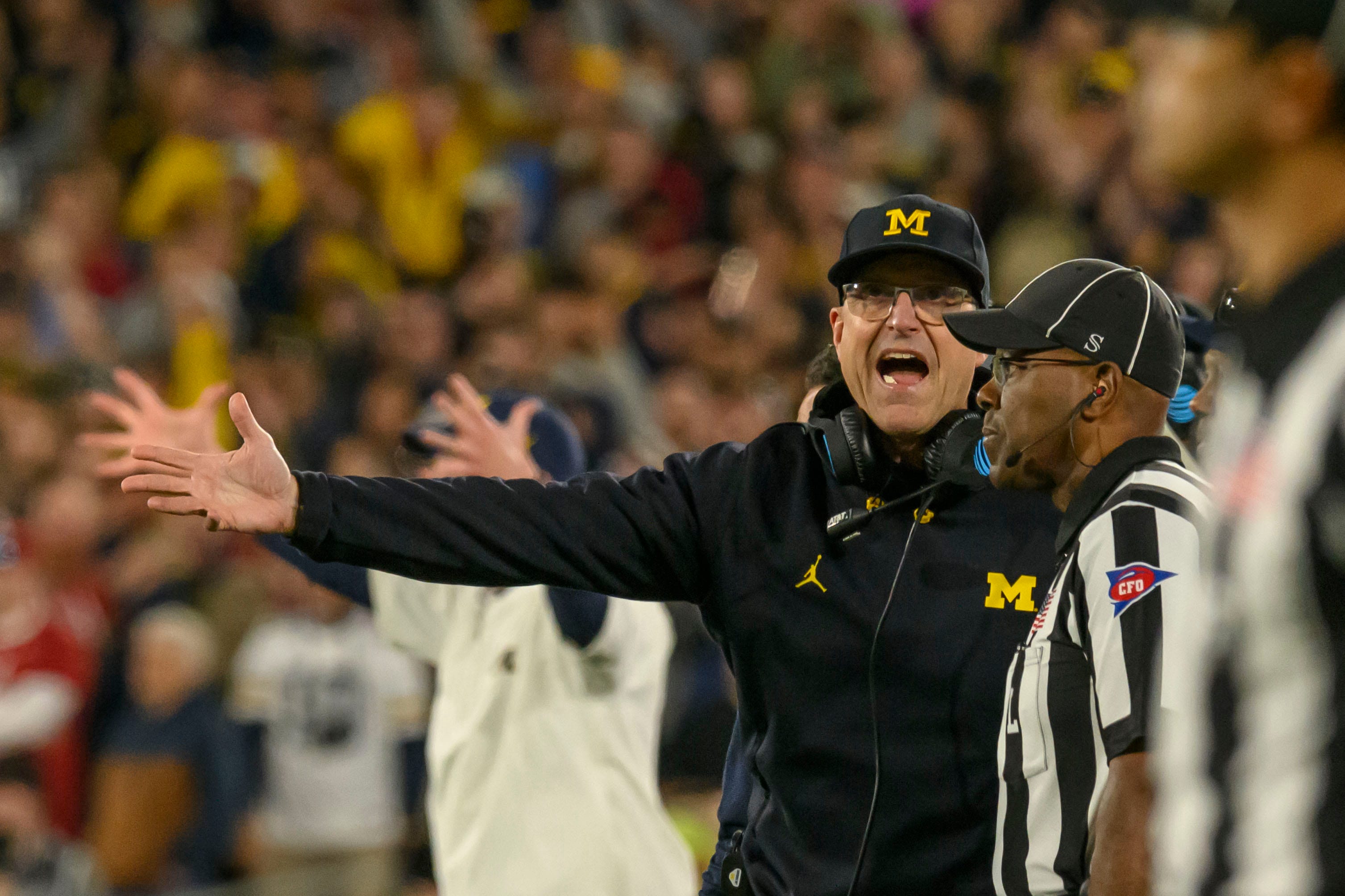 Michigan head coach Jim Harbaugh yells at an official for not calling a penalty on a late hit on quarterback J.J. McCarthy during the fourth quarter of the Rose Bowl, in Pasadena, California, January 1, 2024.