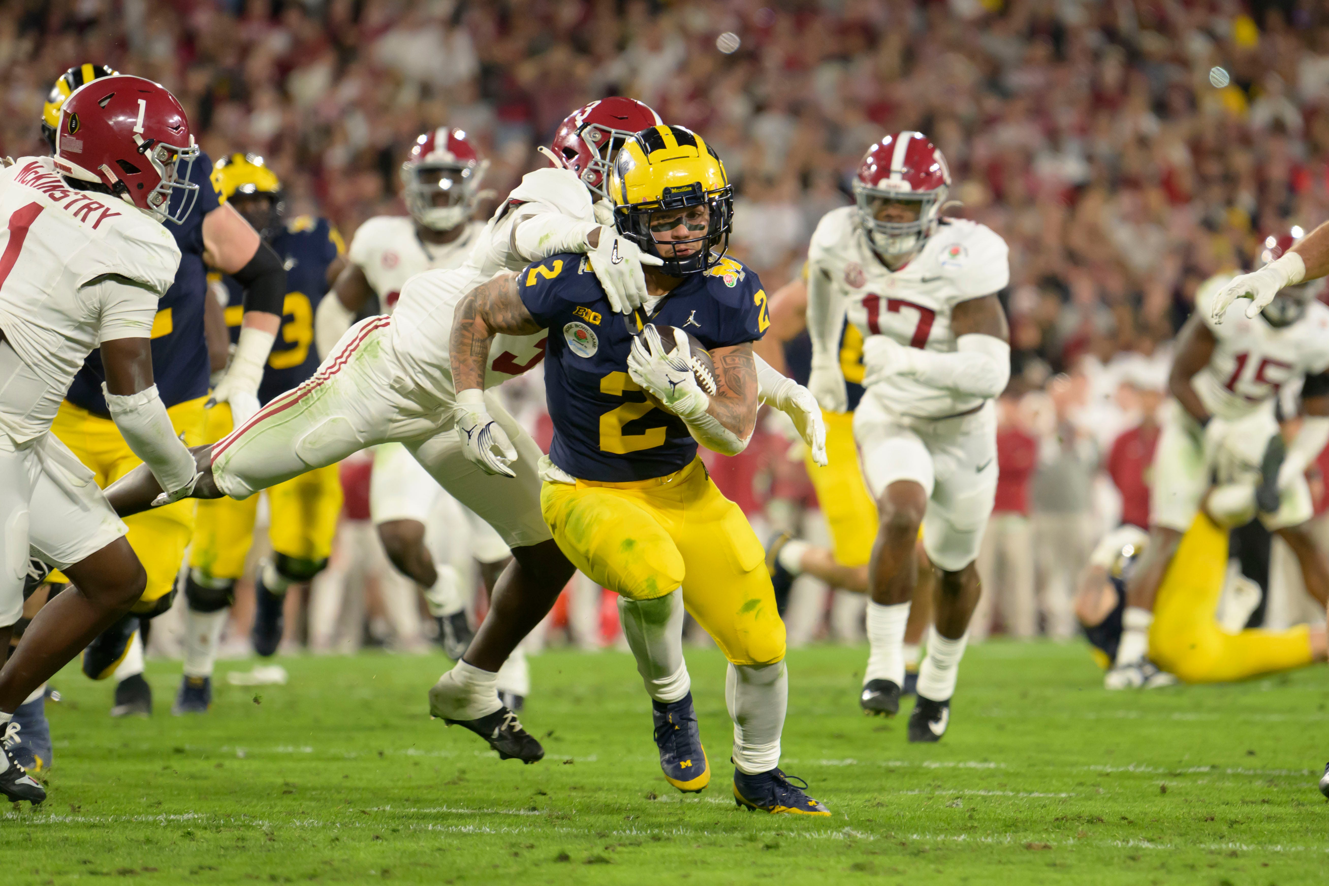 Michigan running back Blake Corum races for the end zone to score a touchdown during the overtime period of the Rose Bowl, in Pasadena, California, January 1, 2024.