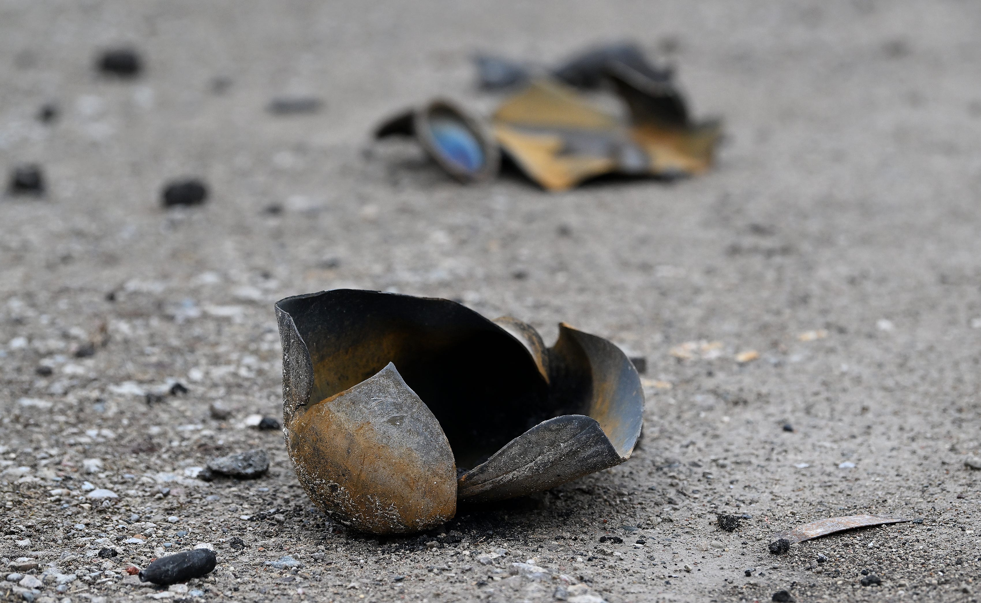 Exploded canisters are strewn around the area near Select Distributors and Goo LLC in Clinton Township, Mich. on Mar. 5, 2024. Select Distributors was the scene of fire and explosions the night before on March 4, 2024.