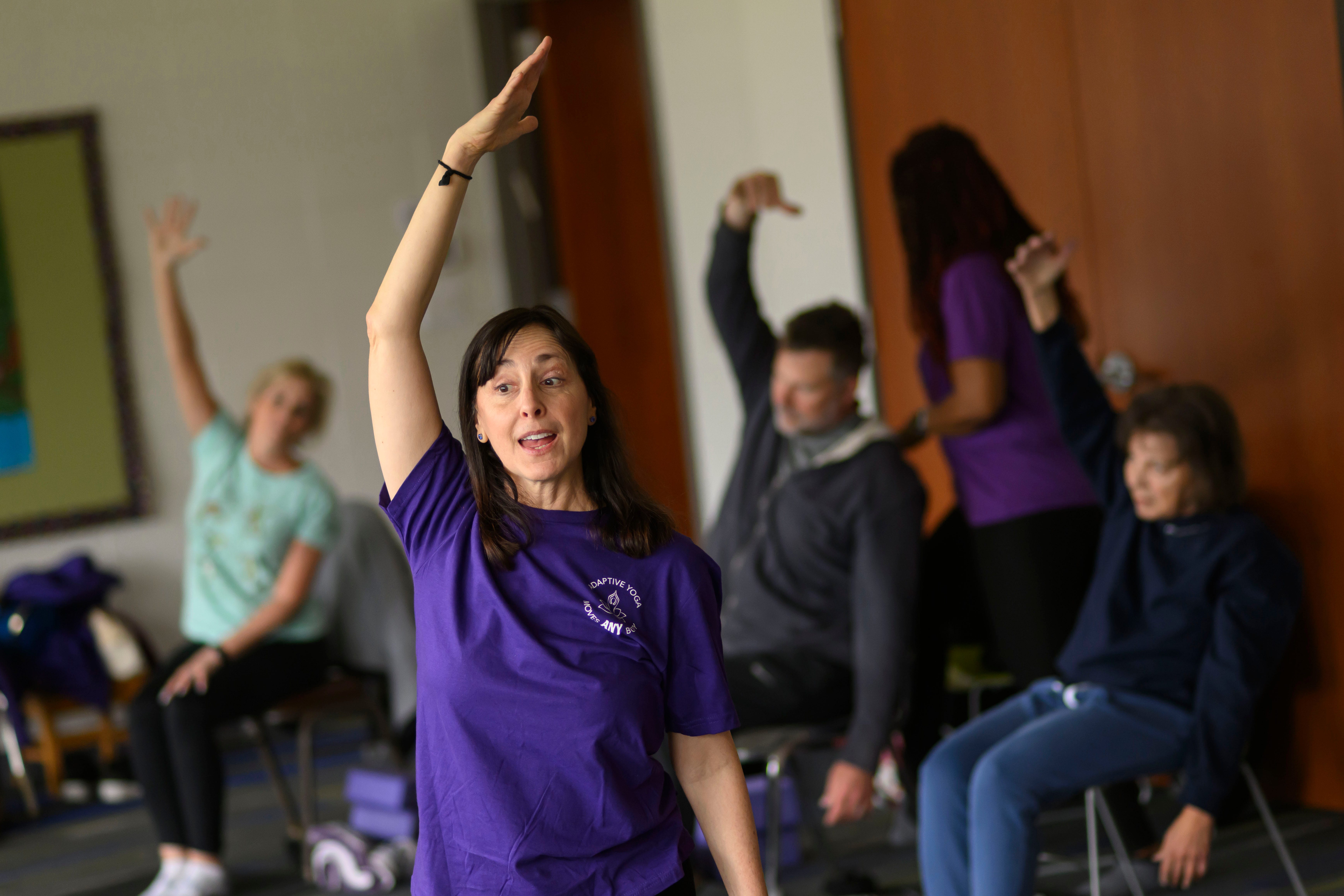 Instructor Mindy Eisenberg leads a stretching exercise during a Yoga Moves Parkinson's class, at Congregation Shaarey Zedek, March 6, 2024. The Kirk Gibson Foundation started the program to offer free yoga classes specifically designed to help people living with Parkinson's Disease.