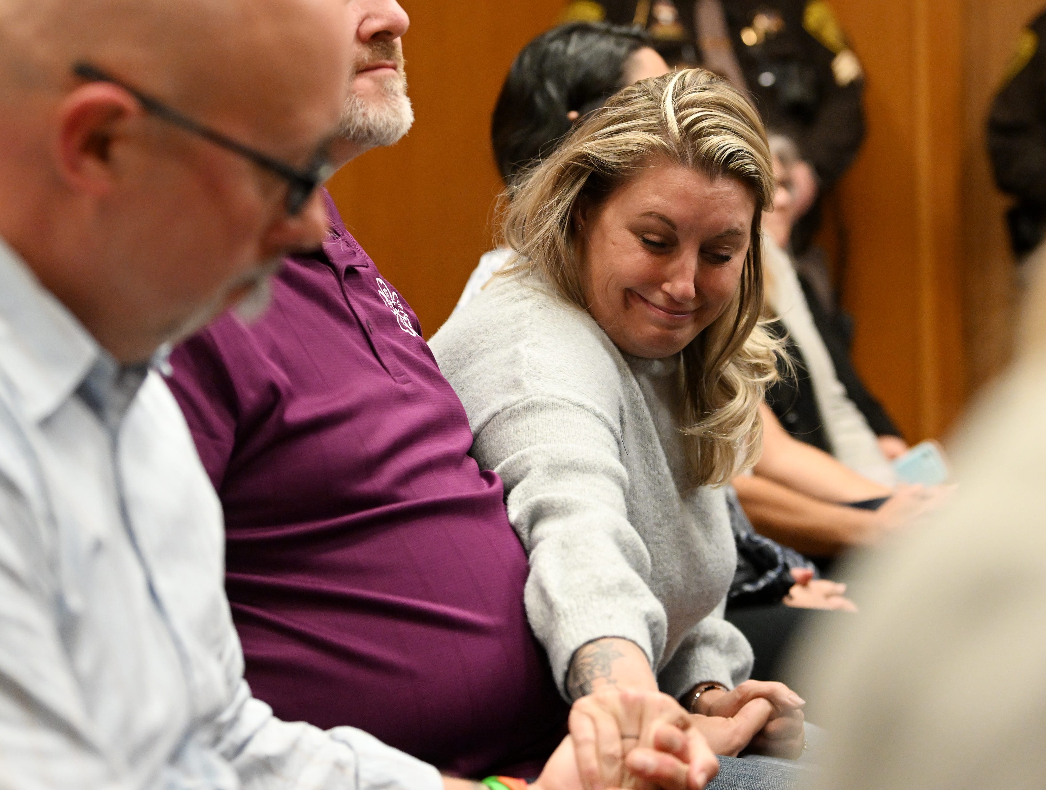 Nicole Beausoleil, mother of Madisyn Baldwin, right, reaches over to grab the hand of Craig Shilling, father of Justin Shilling. Jury finds James Crumbley guilty of involuntary manslaughter in the courtroom of Cheryl Matthews in Oakland County Court in Pontiac, Mich. on March 14, 2024.