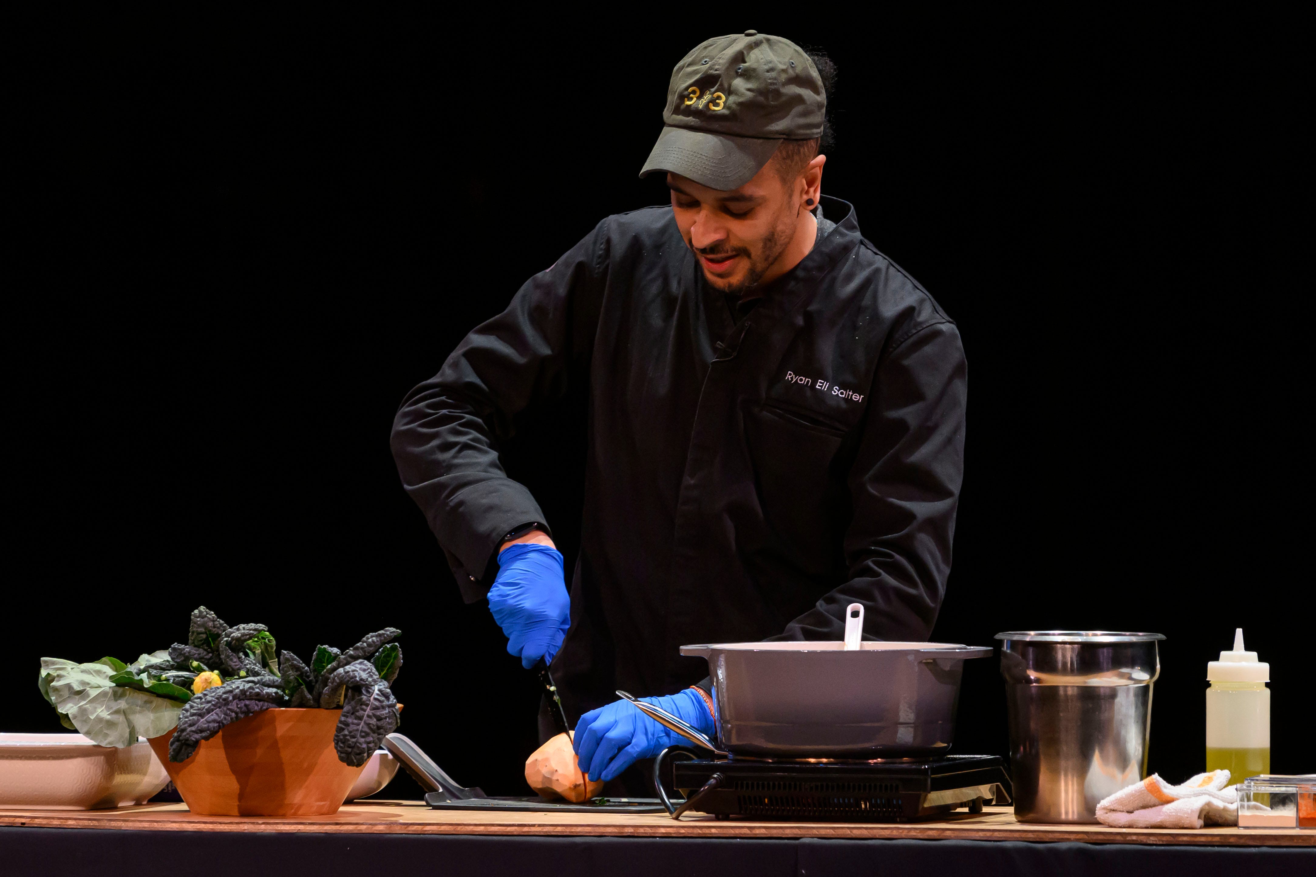 Chef Ryan Salter from Breadless demonstrates how to make a sweet potato, squash, and braised greens bowl during the event series Dish and Design, at the Berman Center for Performing Arts, in West Bloomfield, March 20, 2024.