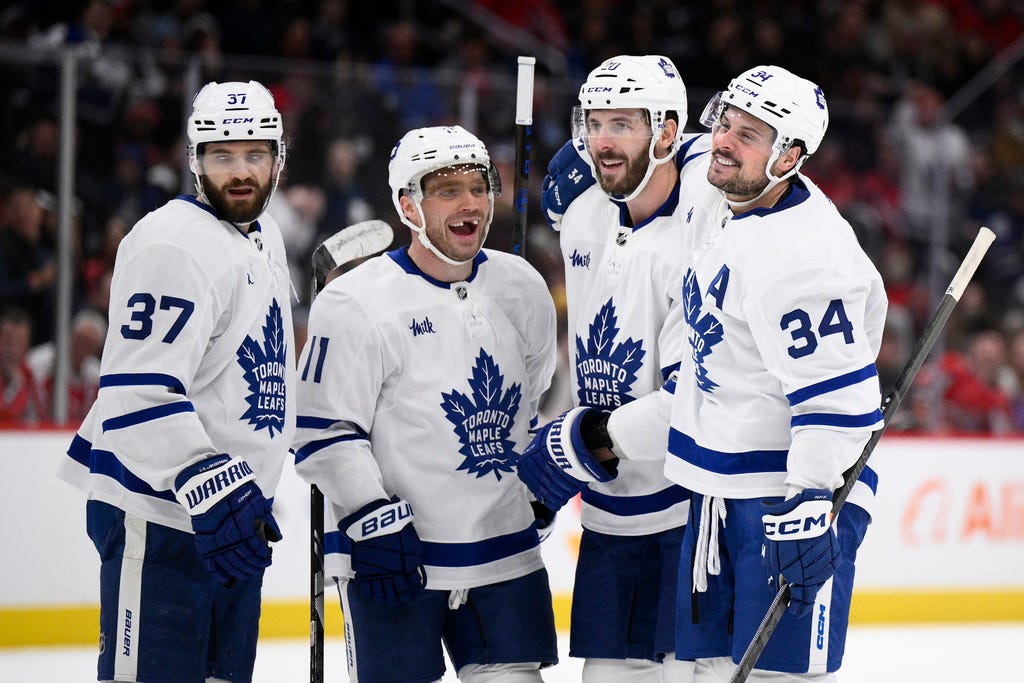 Maple Leafs center Auston Matthews (34) celebrates his goal with defenseman Timothy Liljegren (37), center Max Domi (11) and defenseman Joel Edmundson (20) during the second period of Wednesday's victory against the Capitals in Washington.