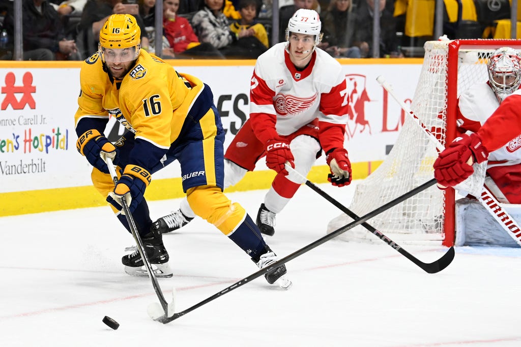 Predators left wing Jason Zucker (16) tries to get control of the puck against the Red Wings during the second period.