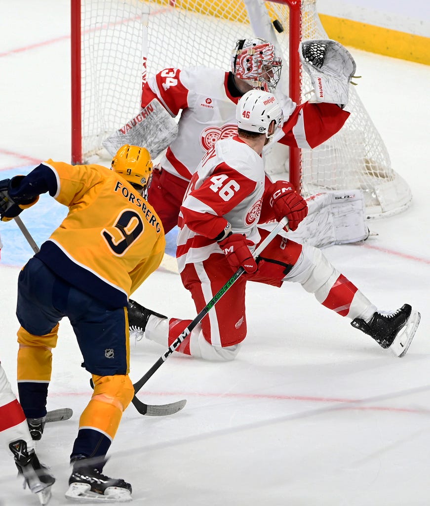 Predators left wing Filip Forsberg (9) scores a goal past Red Wings defenseman Jeff Petry (46) and goaltender Alex Lyon (34) during the third period.