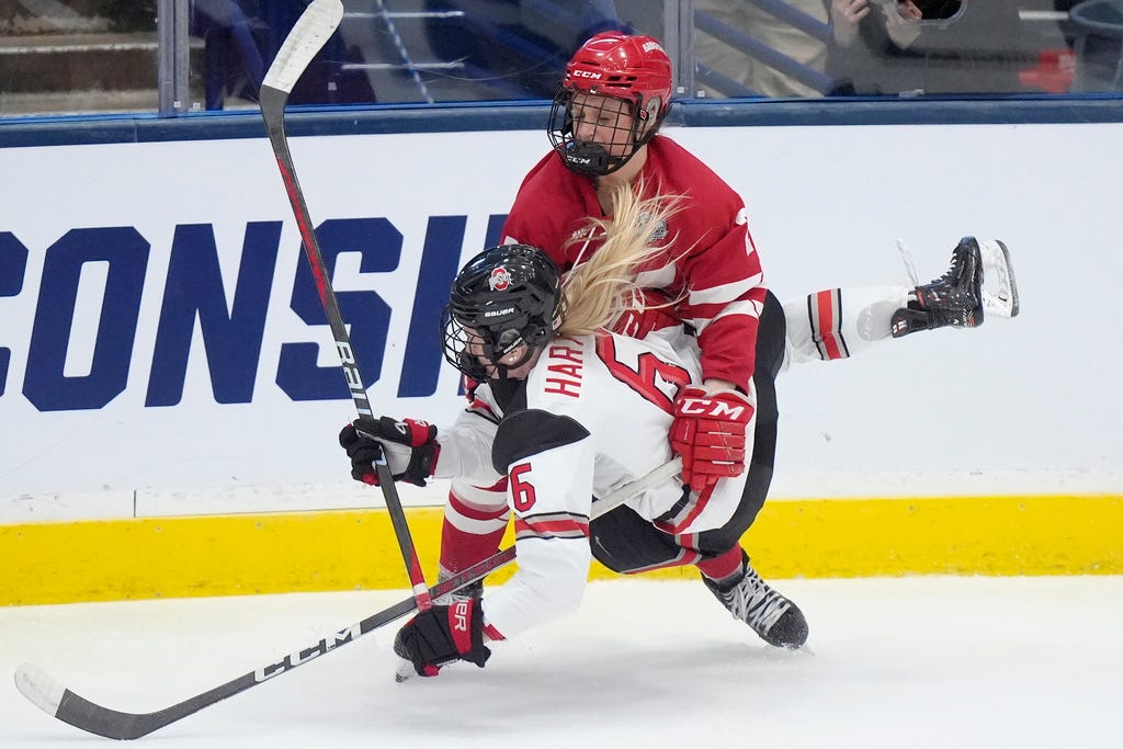 Plymouth's Kirsten Simms, back, collides with Ohio State defenseman Hadley Hartmetz in the second period of Sunday's NCAA college women's championship hockey game in Durham, N.H.