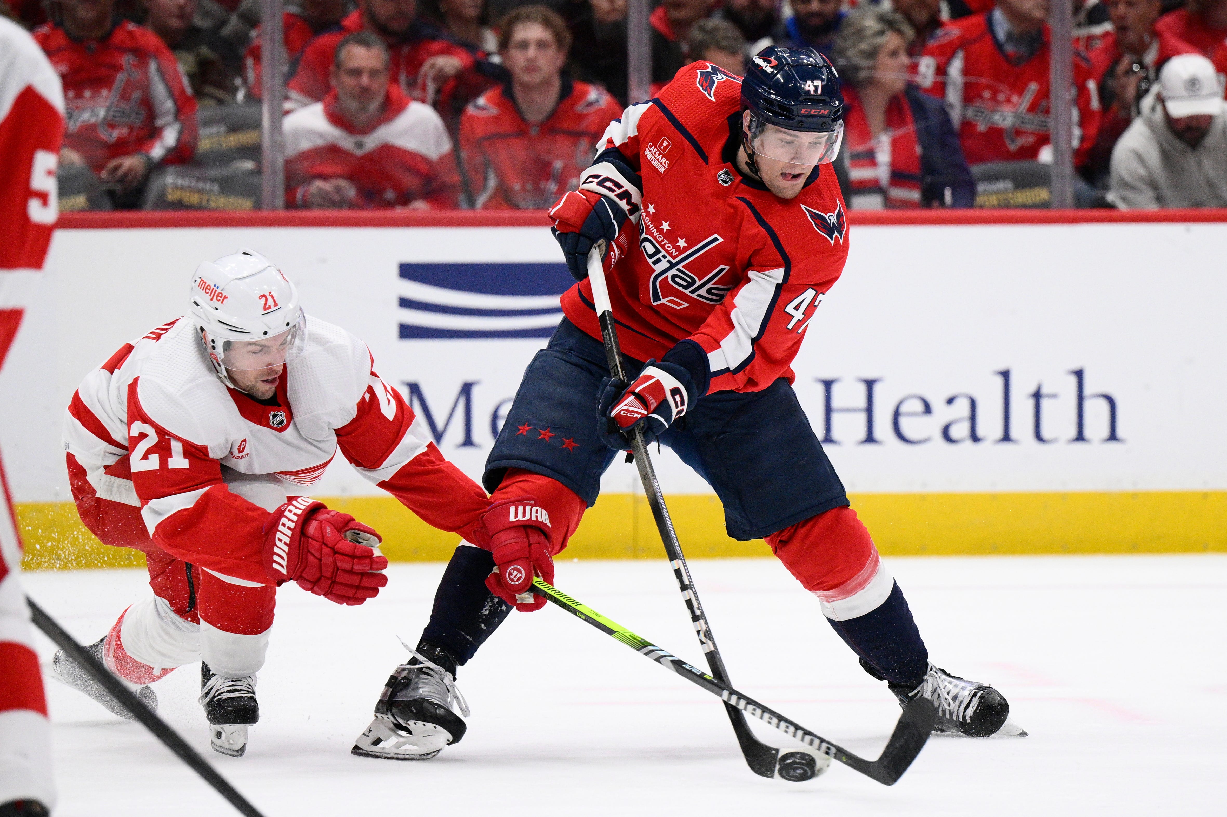 Washington Capitals left wing Beck Malenstyn (47) skates with the puck against Detroit Red Wings center Austin Czarnik (21)during the first period.