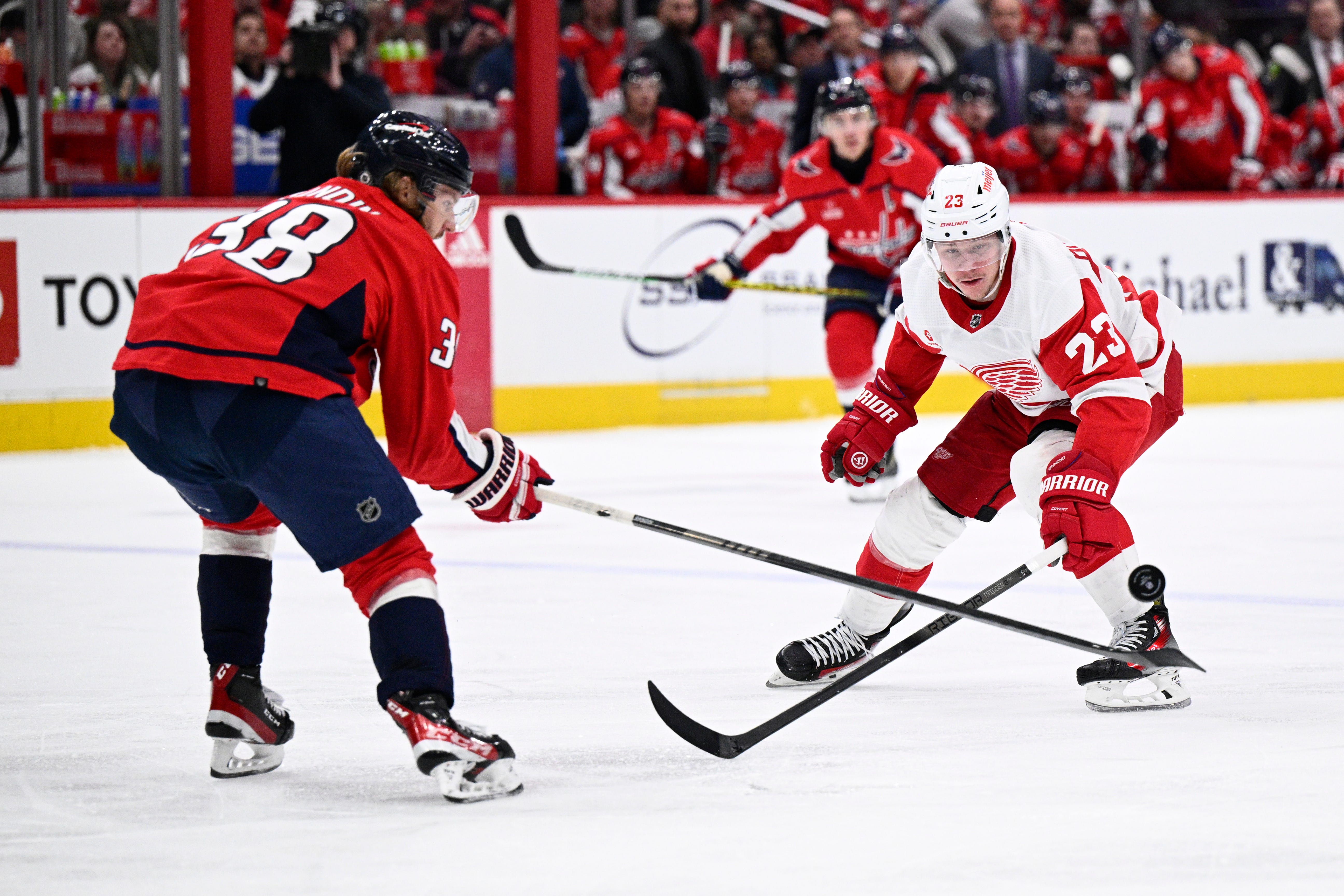 Detroit Red Wings left wing Lucas Raymond (23) battles for the puck against Washington Capitals defenseman Rasmus Sandin (38) during the second period.